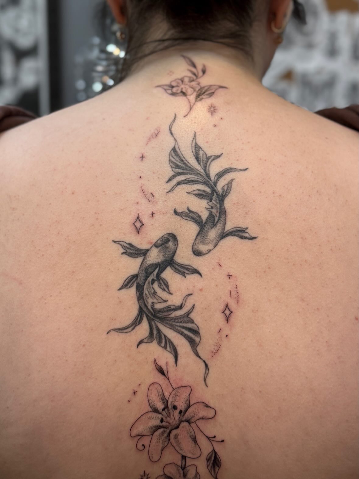 Koi fish and lily black and grey tattoo on the back by Kamakana Pankiwska