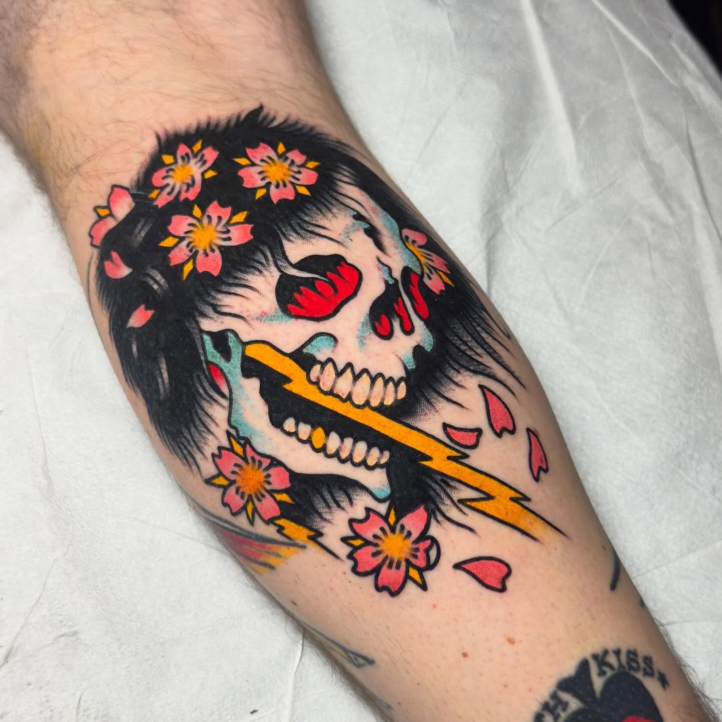 Skull with cherry blossoms American traditional tattoo on the forearm by 𝐬𝐚𝐬𝐡𝐚 𝐯𝐚𝐧𝐝𝐚𝐥, Nashville, Tennessee
