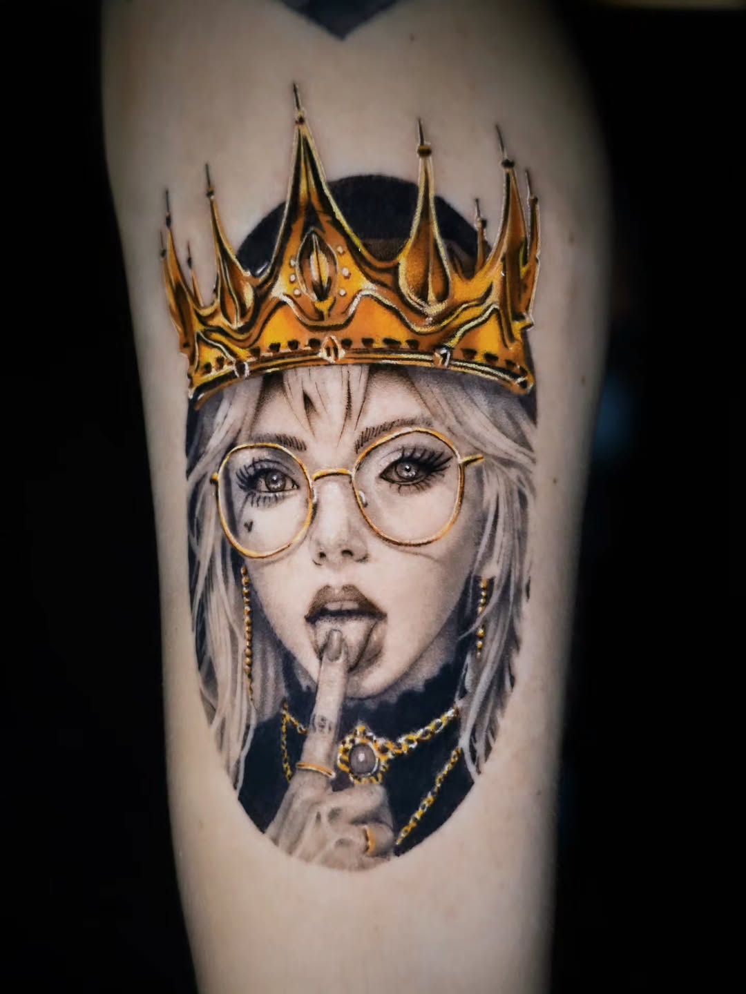 Woman with crown and glasses realism tattoo on the forearm by Jake Barney