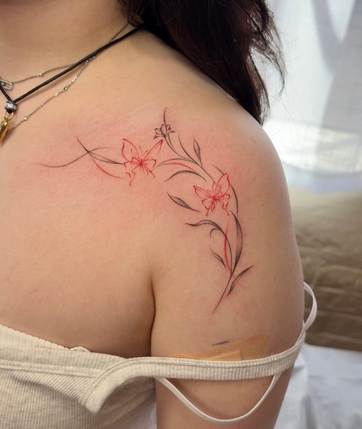 Butterflies and flowers fine line tattoo on the shoulder by Ethan