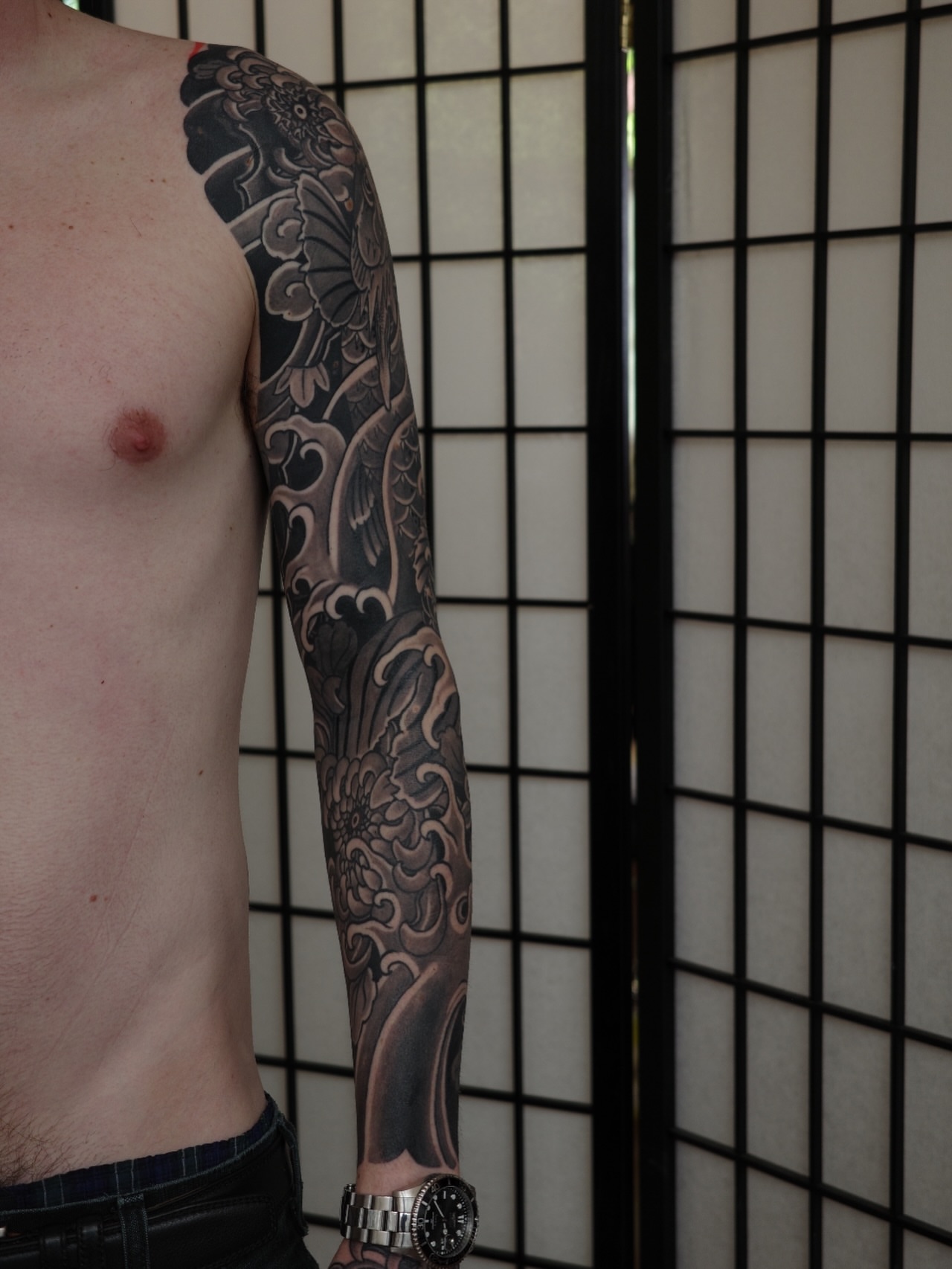 Floral and wave design japanese irezumi tattoo on the upper arm by Innokenty Meshchakov, Portland, Oregon