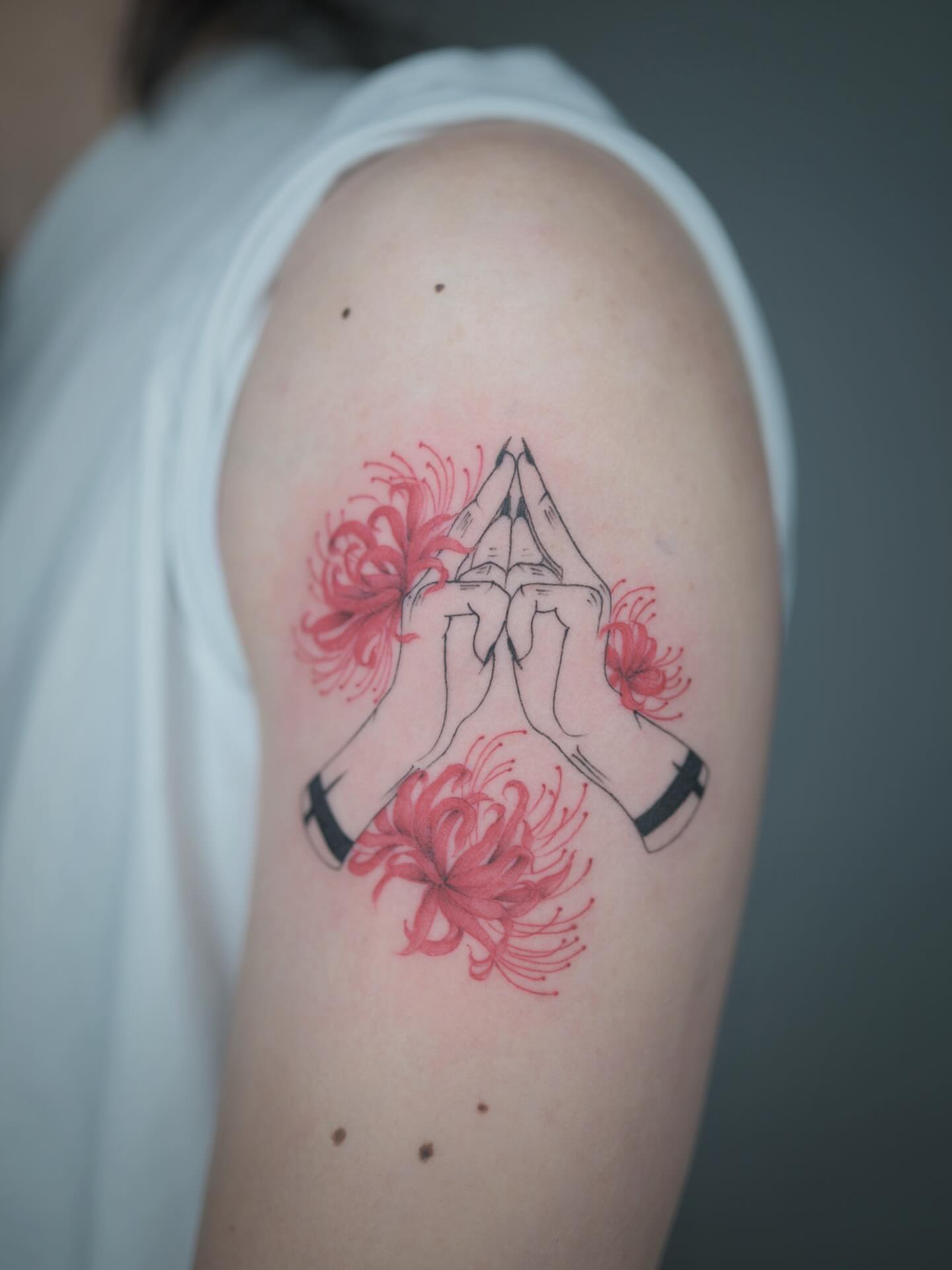 Praying hands with flowers neo-traditional tattoo on the shoulder by Seattle tattoo artist-Mia