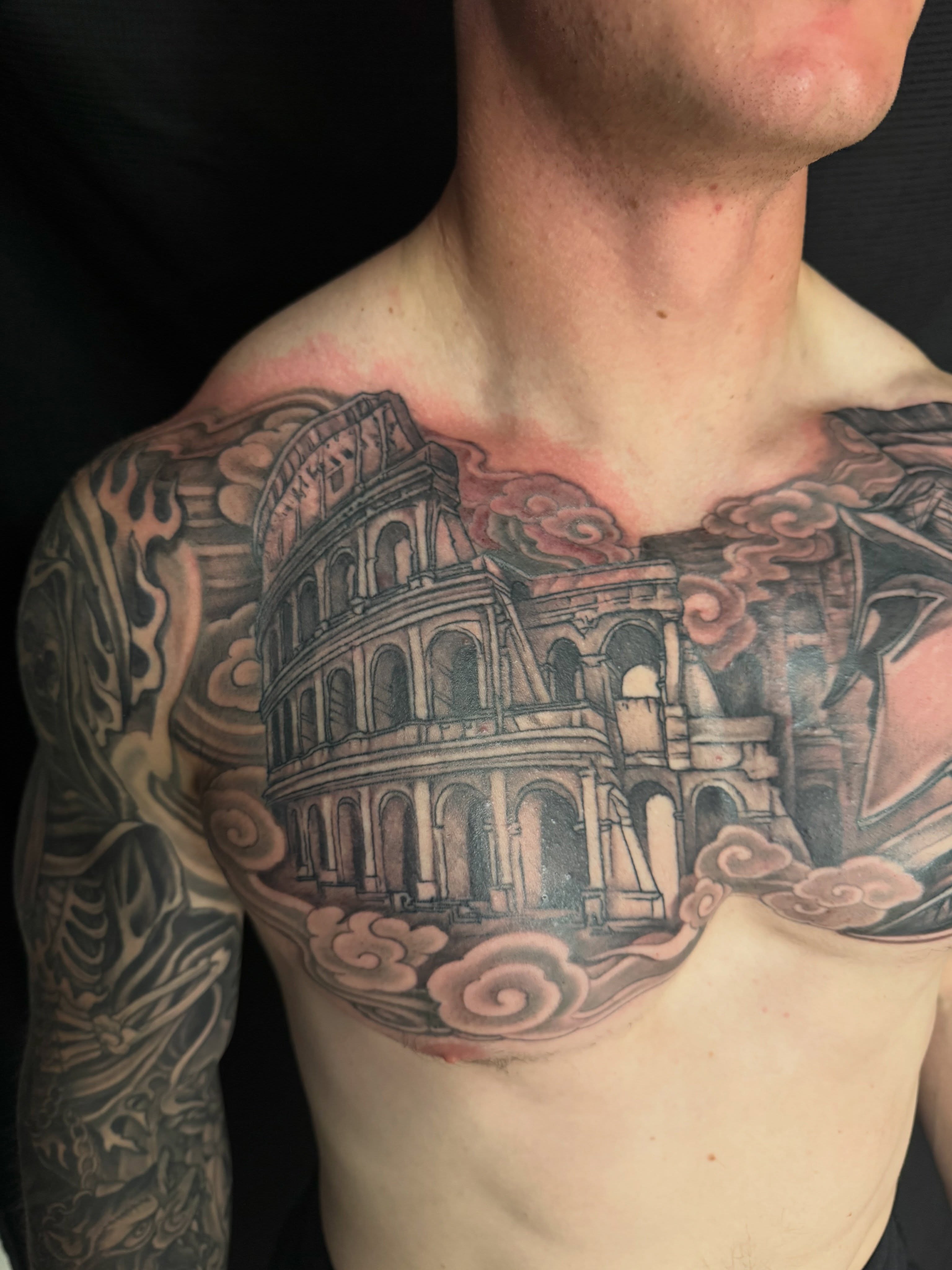 Colosseum black and grey tattoo on the chest by Brian Hutflies