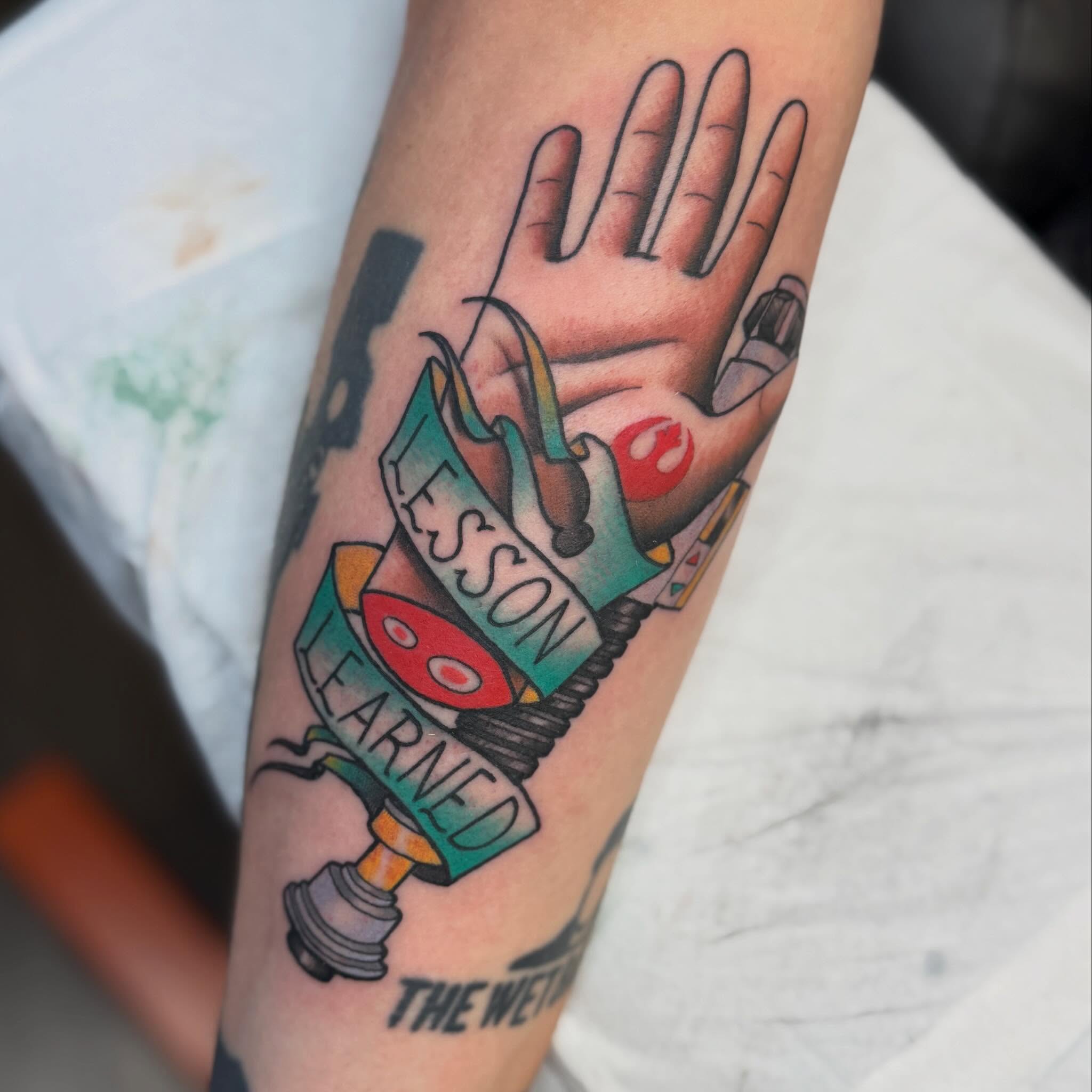 Hand with book American traditional tattoo on the forearm by Chase Martines