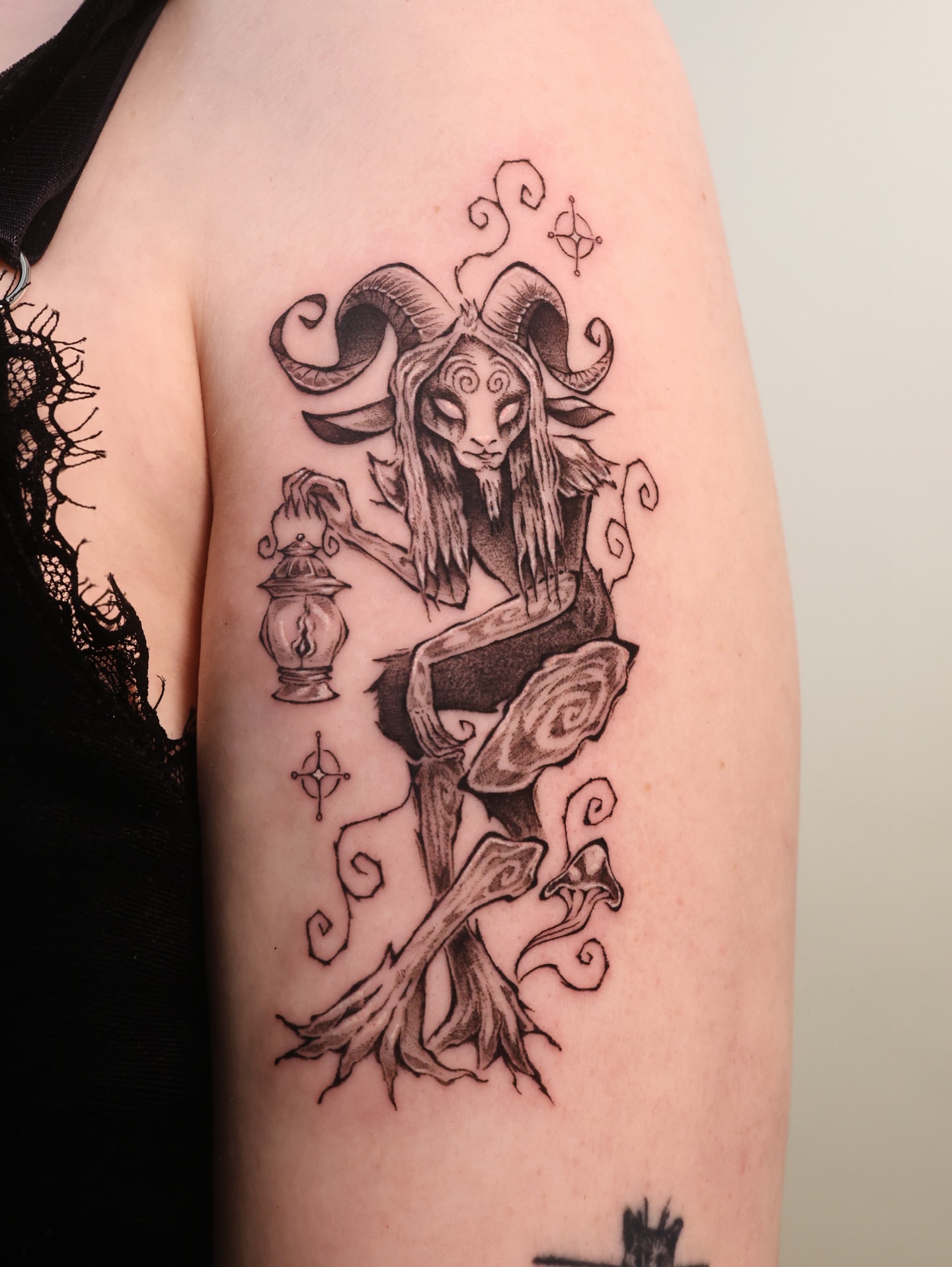 Goat-like creature black and grey tattoo on the upper arm by ââŪ. Ý ðķðð―ððð âðĶđËâ seattle tattoo artist, Seattle, Washington