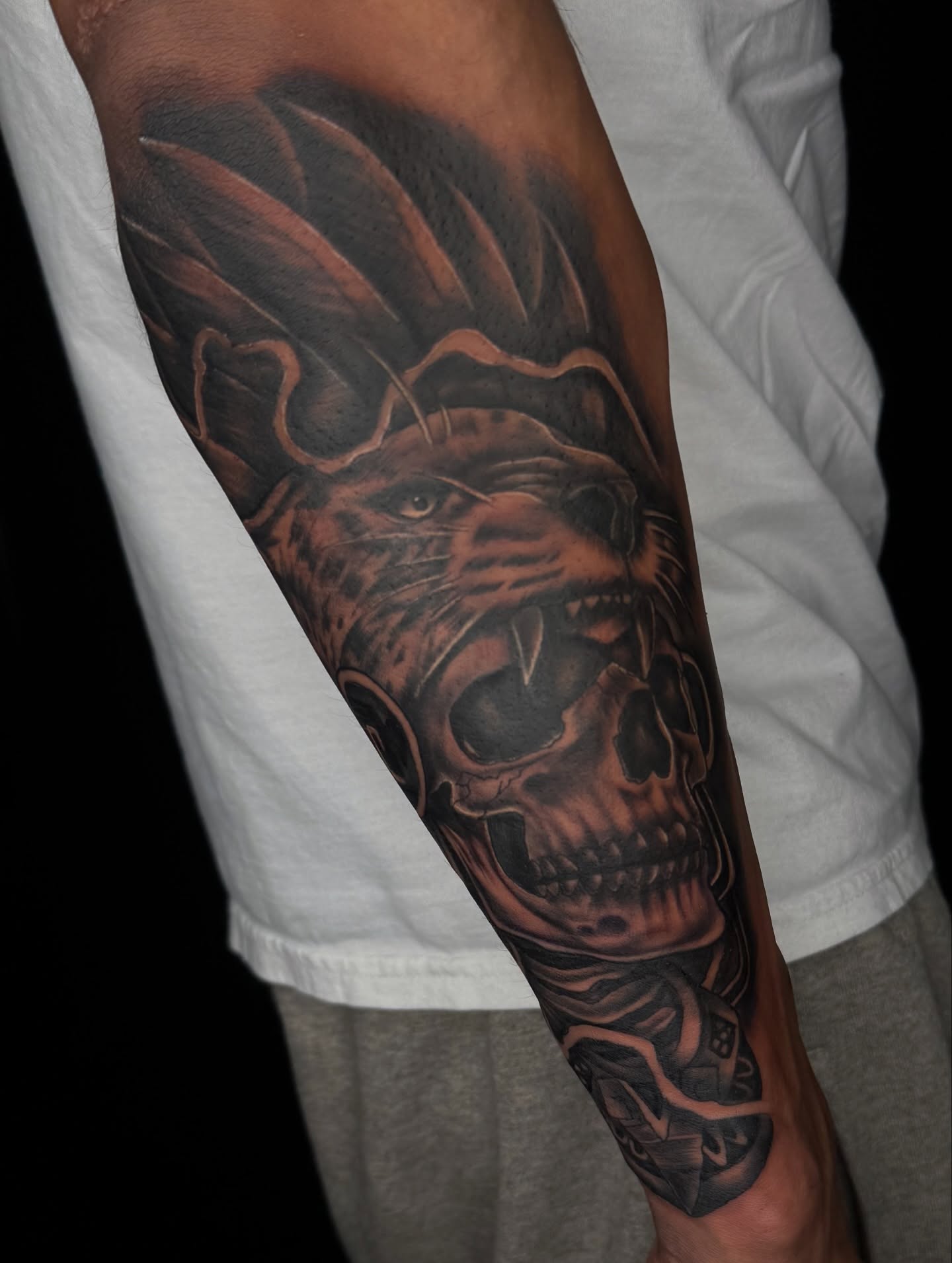 Skull and lion realism tattoo on the forearm by Elijah East