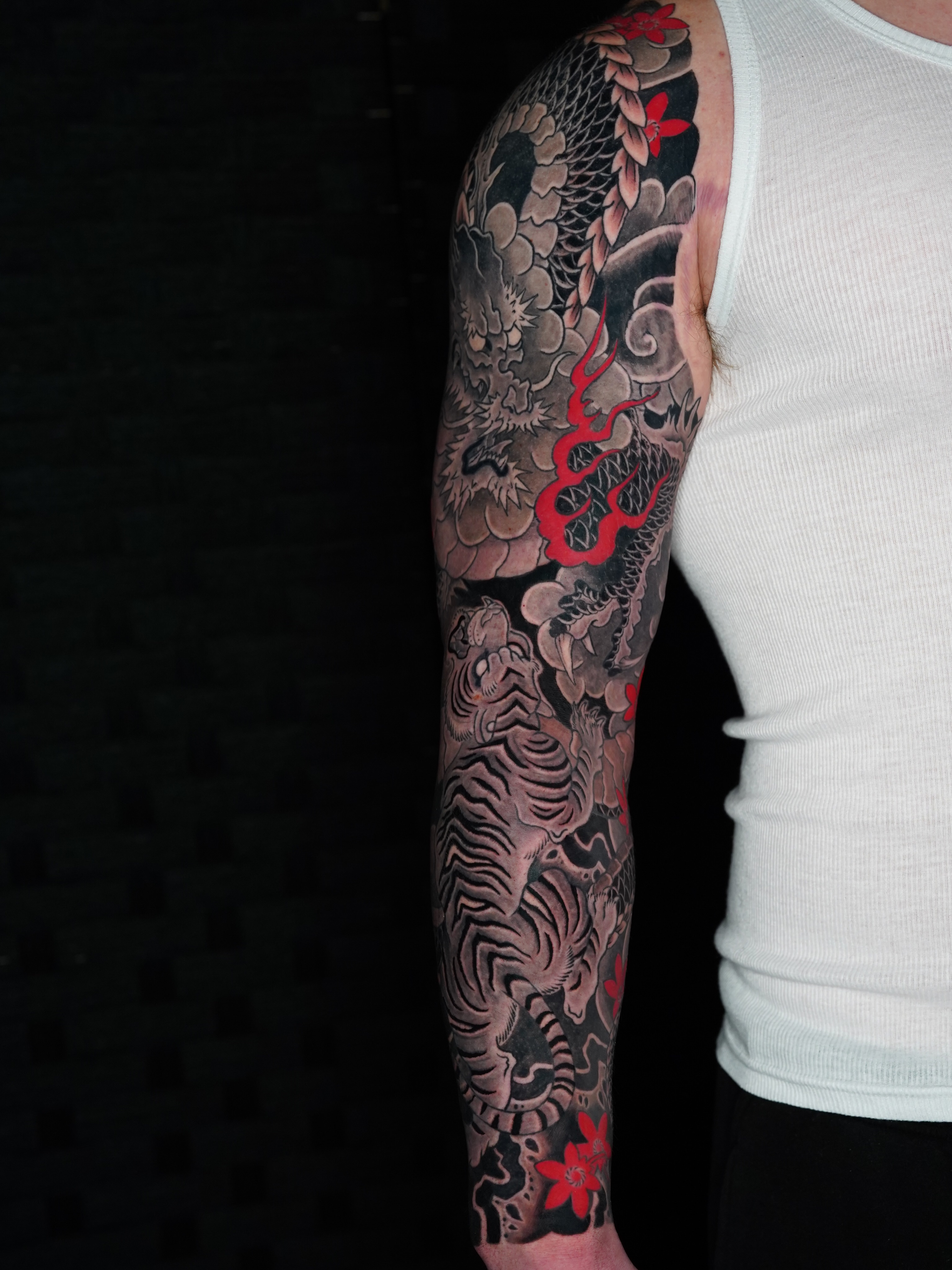 Dragon and tiger sleeve Japanese tattoo on the upper arm by Mitch Bonifay