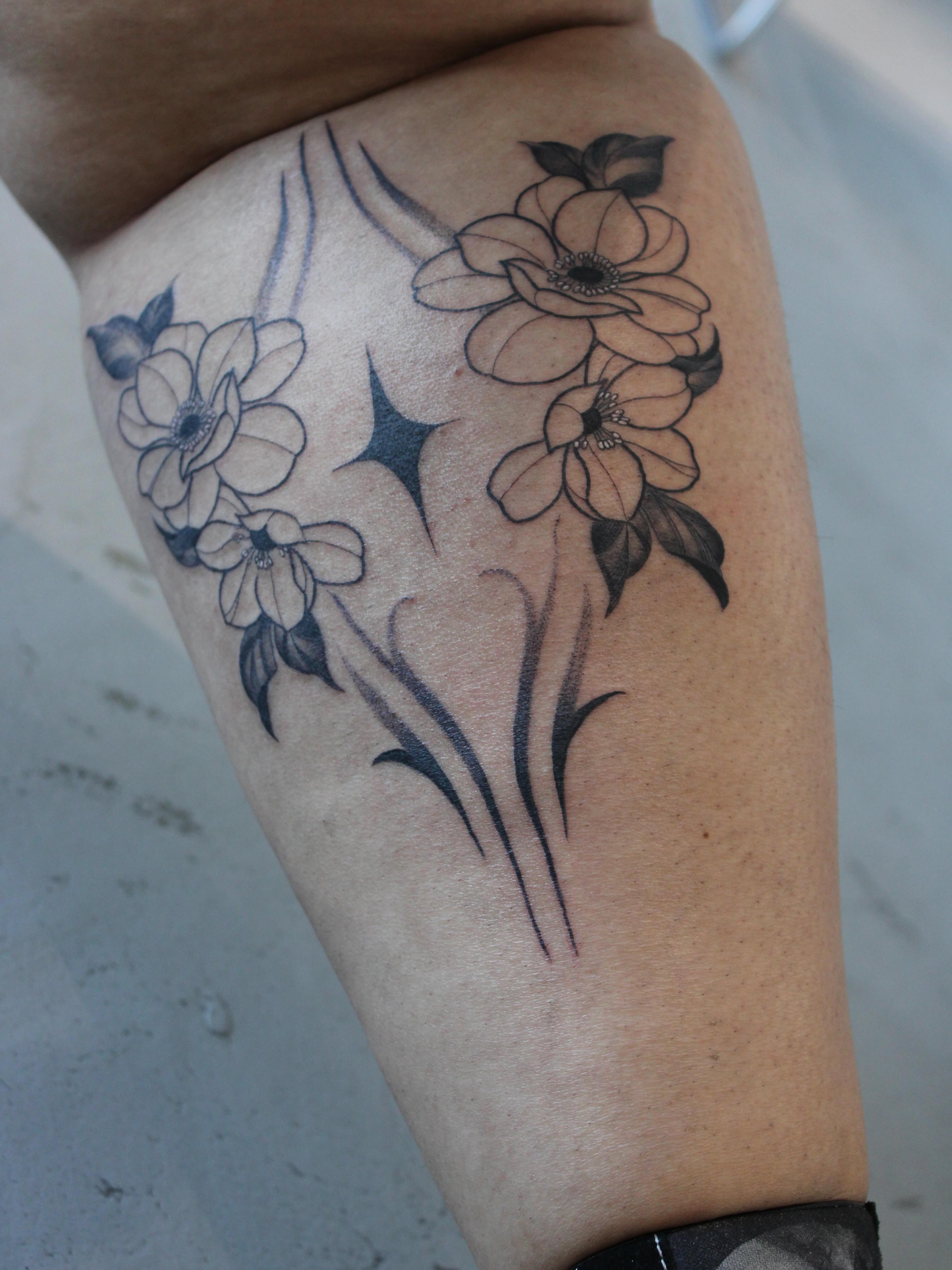 Flowers black and grey tattoo on the thigh by Julianna