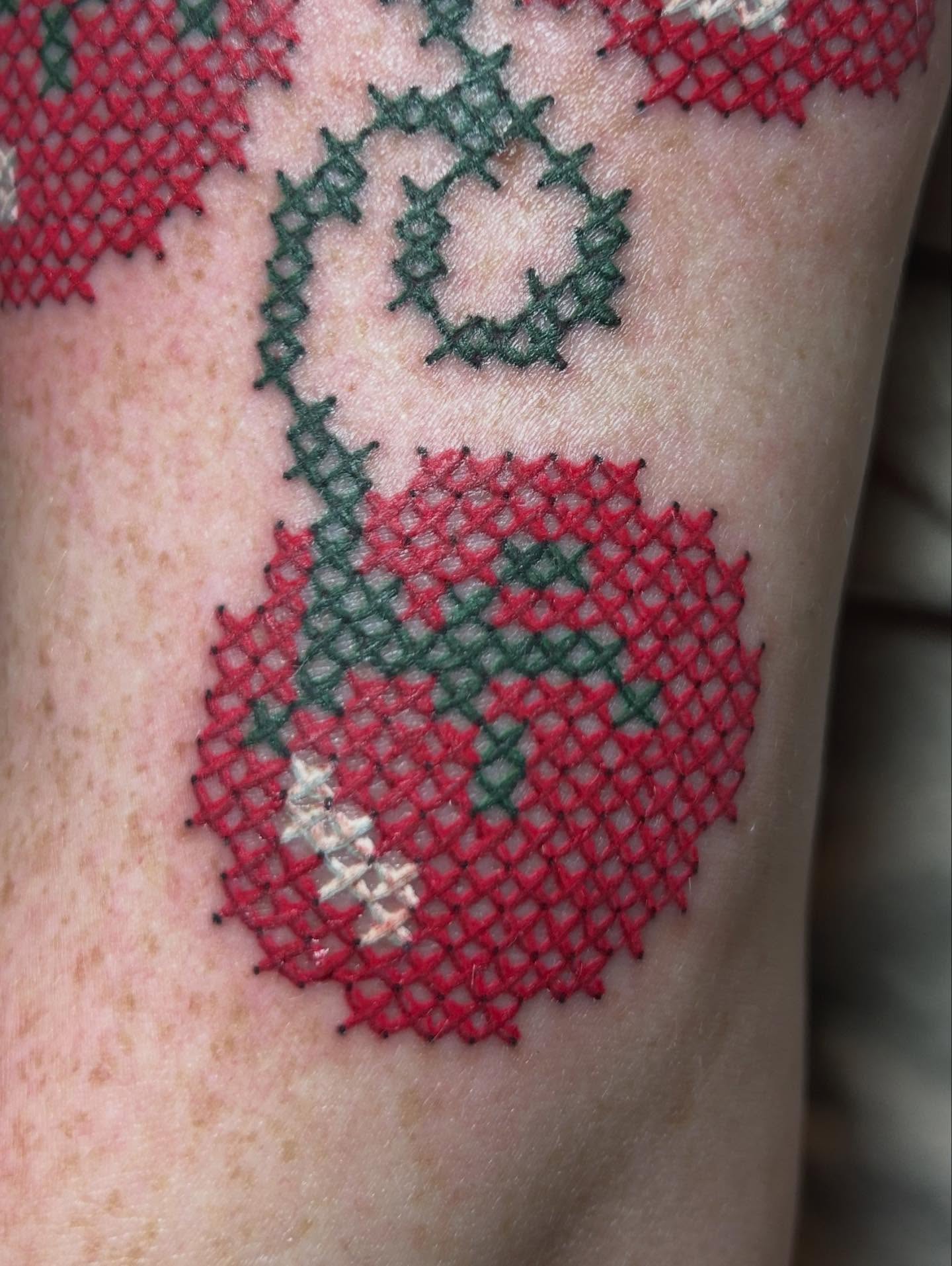 Cross-stitch pattern tattoo on the forearm by Mary Rose Heckle