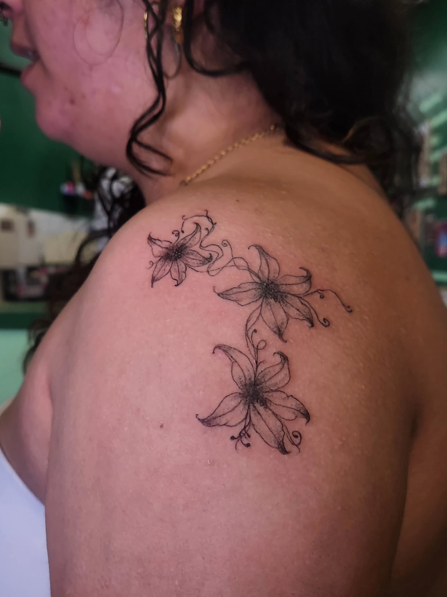 Flowers black and grey tattoo on the shoulder by Tattoos by River