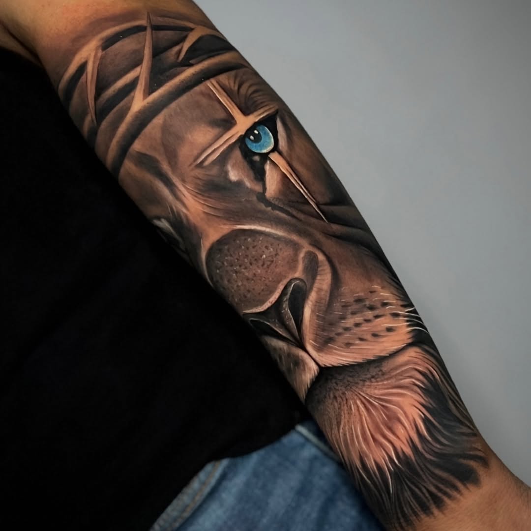 Lion face with crown of thorns Chicano tattoo on the forearm by ⚜️Lalo Godina Tattoo⚜️