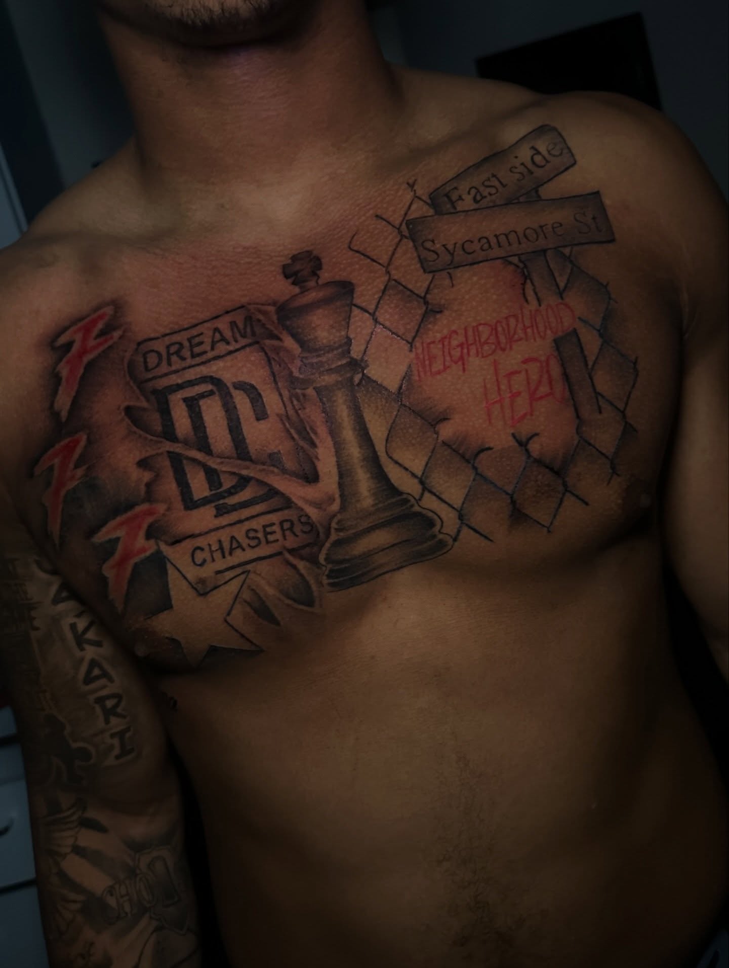 Chess king and street signs realism tattoo on the chest by @tattedbytuck