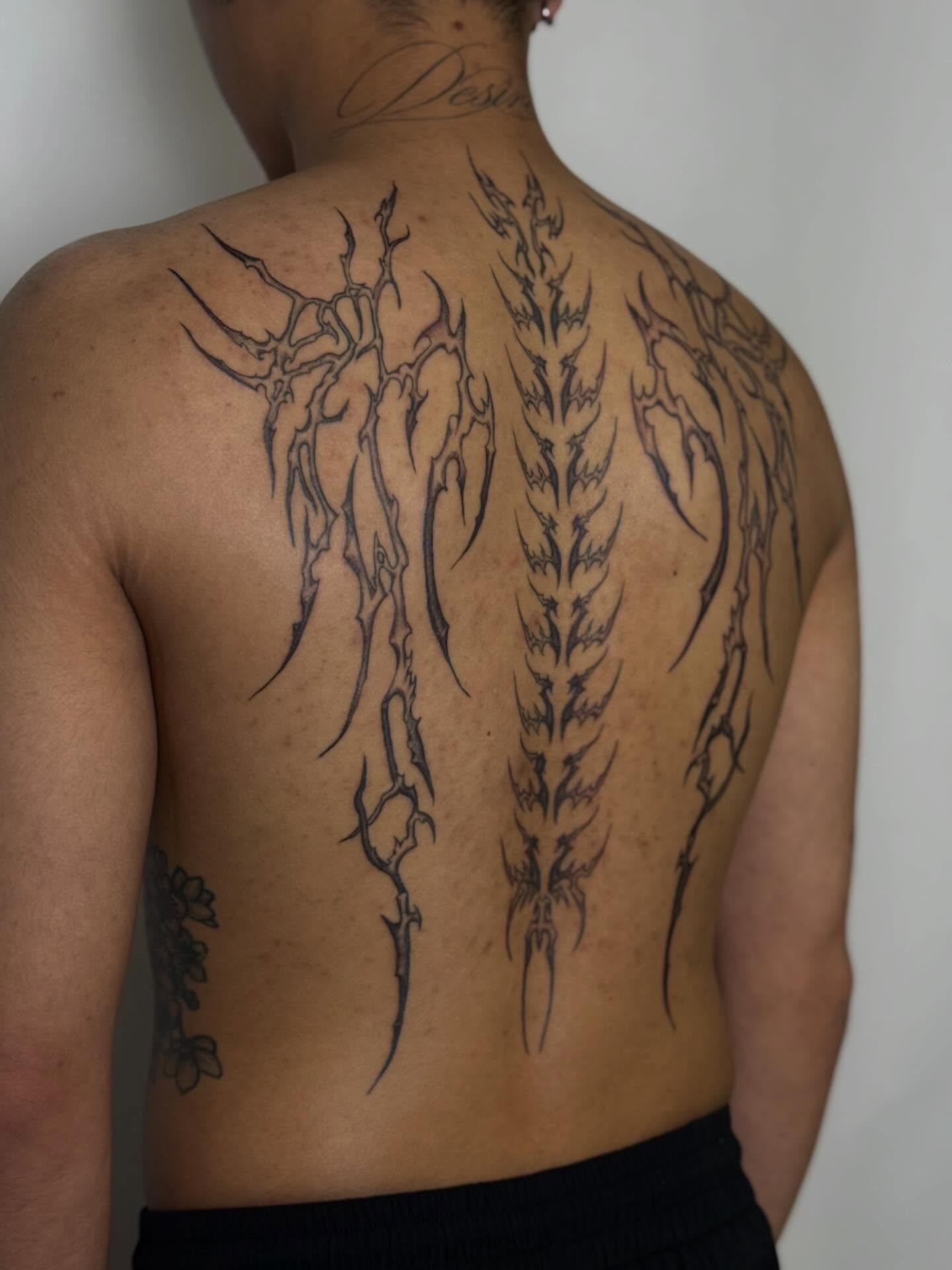 Spine tribal tattoo on the back by Nevaeh tattoo artist