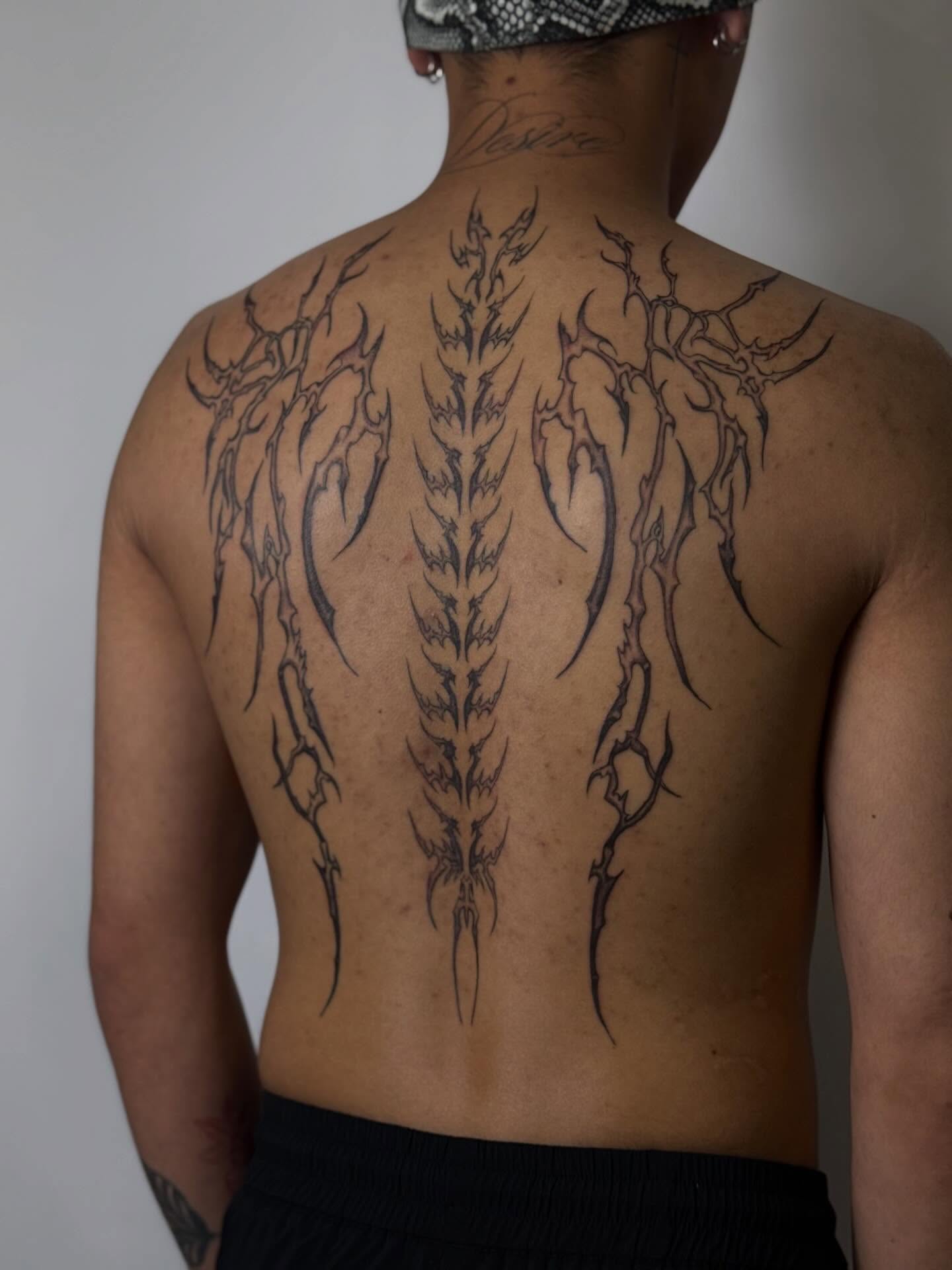 Spine tribal tattoo on the back by Nevaeh tattoo artist