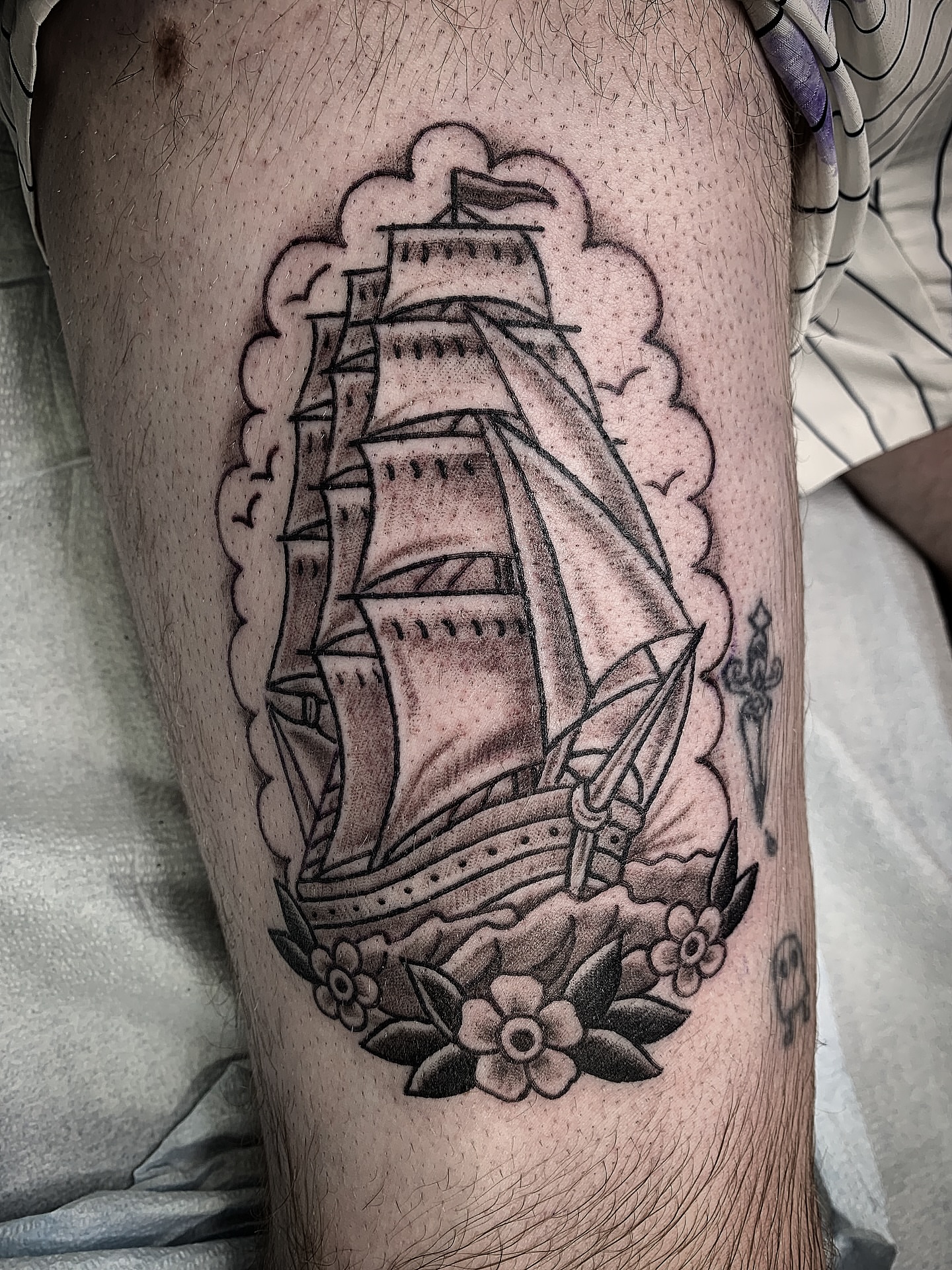 Sailboat American traditional tattoo on the thigh by Destroy Troy