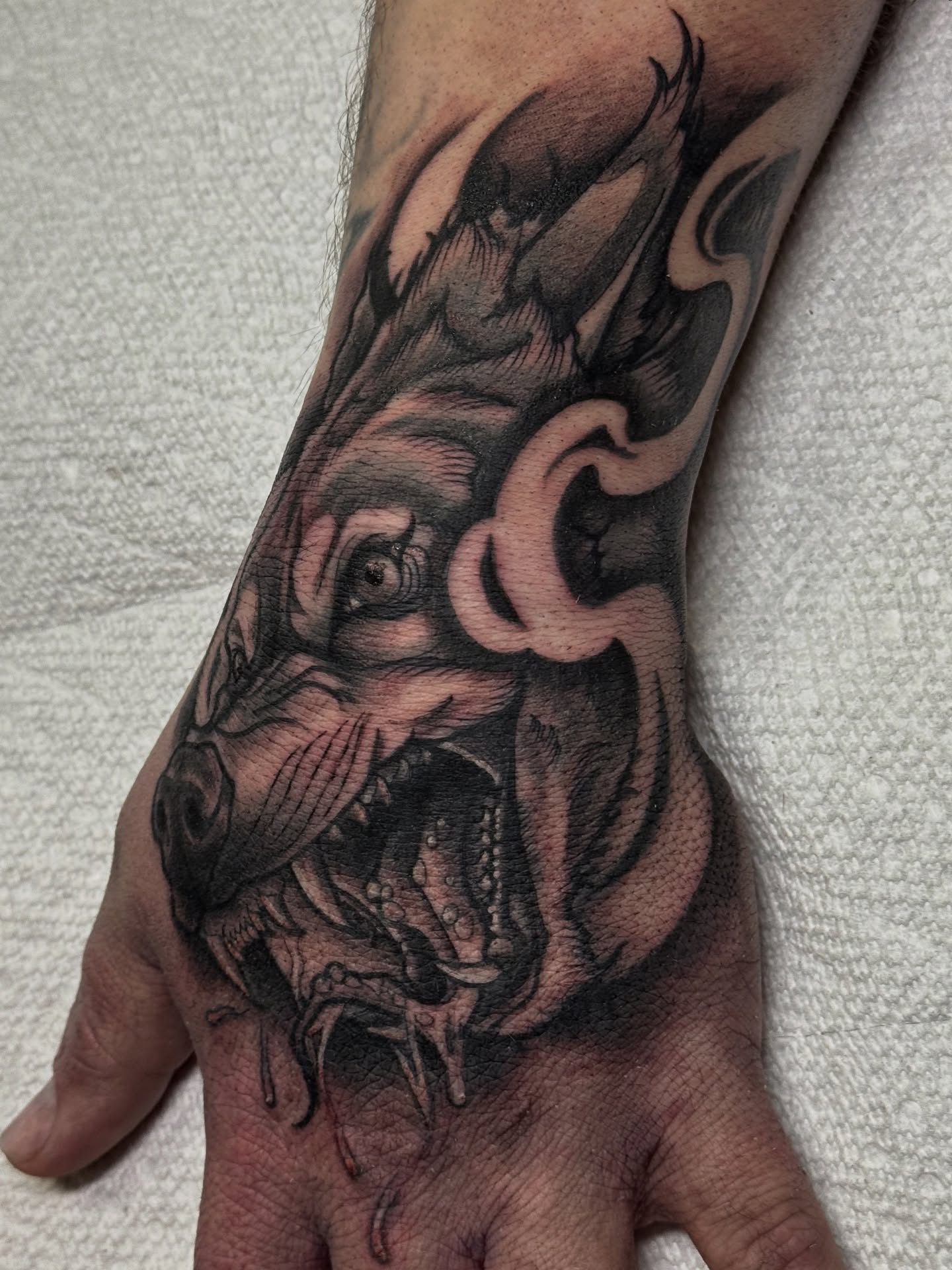 Boar head realism tattoo on the hand by Mitch McGarry