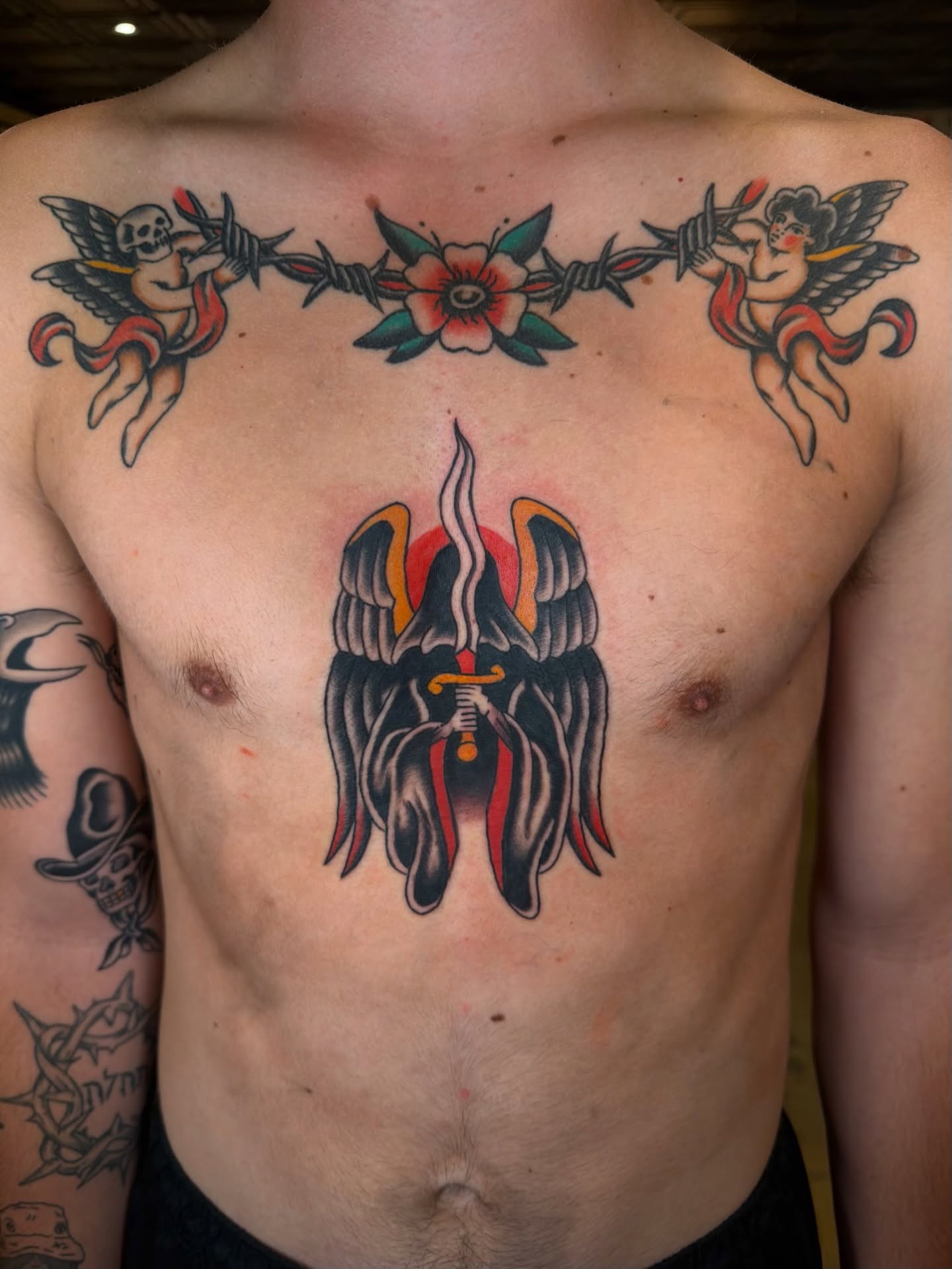 Wings and sword American traditional tattoo on the chest by Tyler Brown, San Diego, California