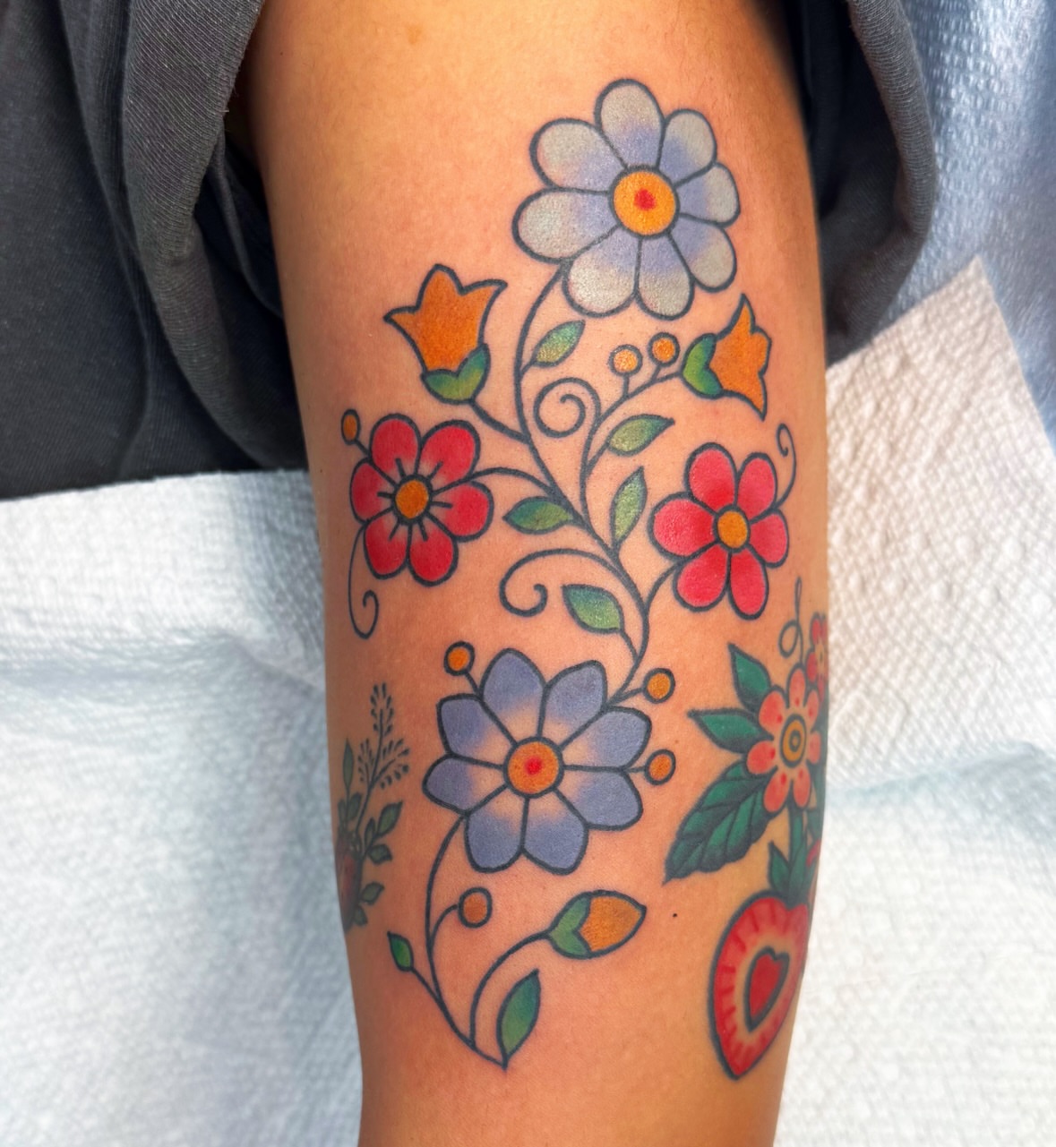 Floral bouquet new school tattoo on the forearm by Lisa Del Toro