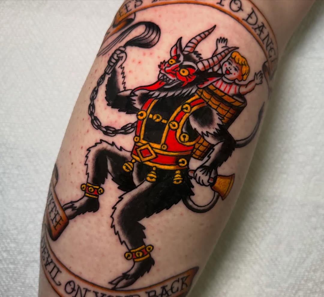 Devil carrying a child American traditional tattoo on the forearm by @michaelryan_tattoo