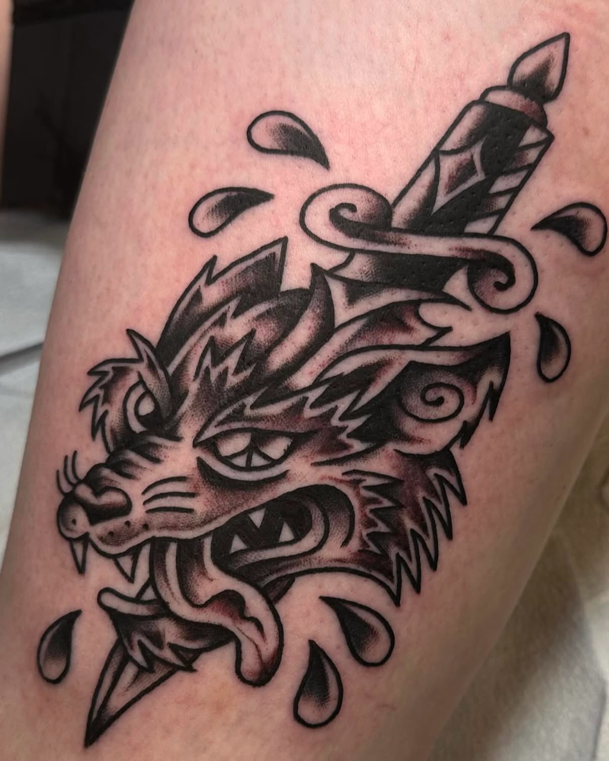 Wolf head with dagger American traditional tattoo on the forearm by ࿊ Emma Sloan Tattoos ࿊, Austin, Texas