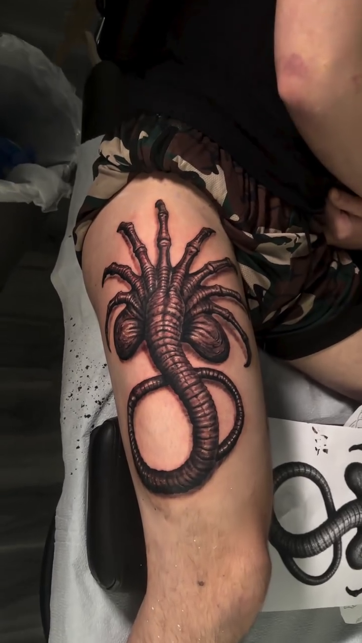 Alien facehugger tattoo surrealism tattoo on the leg by Antonio Massimino
