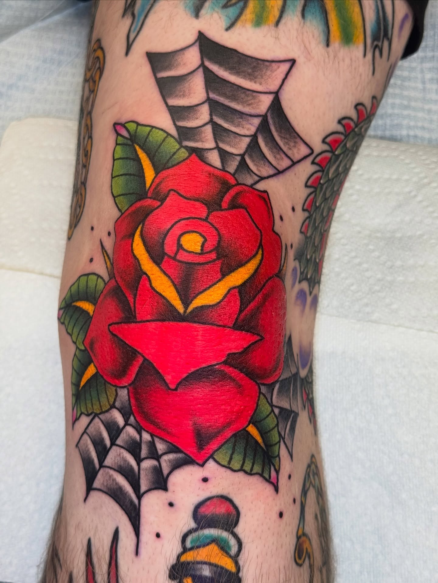Red rose American traditional tattoo on the forearm by Kenneth Gibson