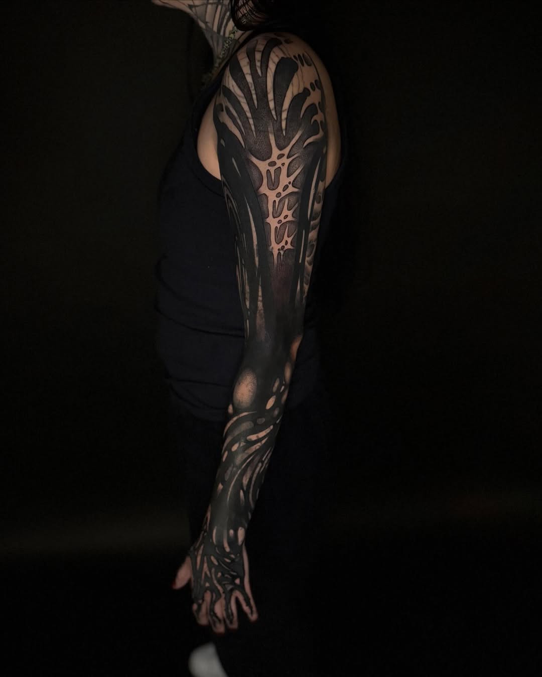 Abstract biomechanical sleeve blackwork tattoo on the upper arm by Dylan Orbock, Berkeley, California