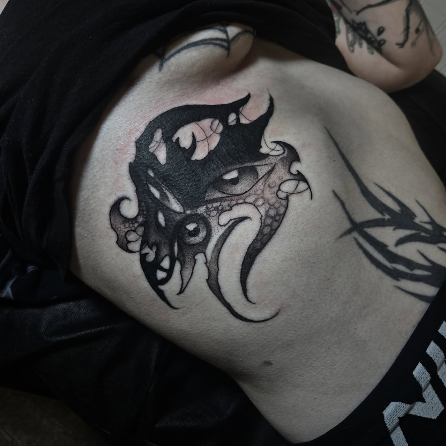 Dragon black and grey tattoo on the torso by Ema Fish