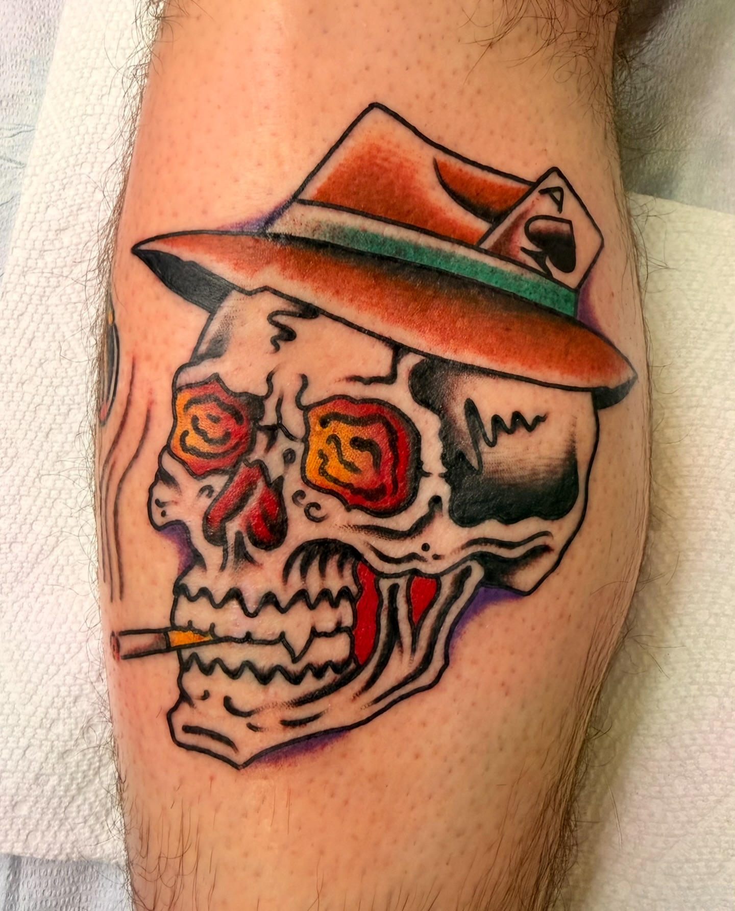Skull wearing hat American traditional tattoo on the forearm by Macy Bird
