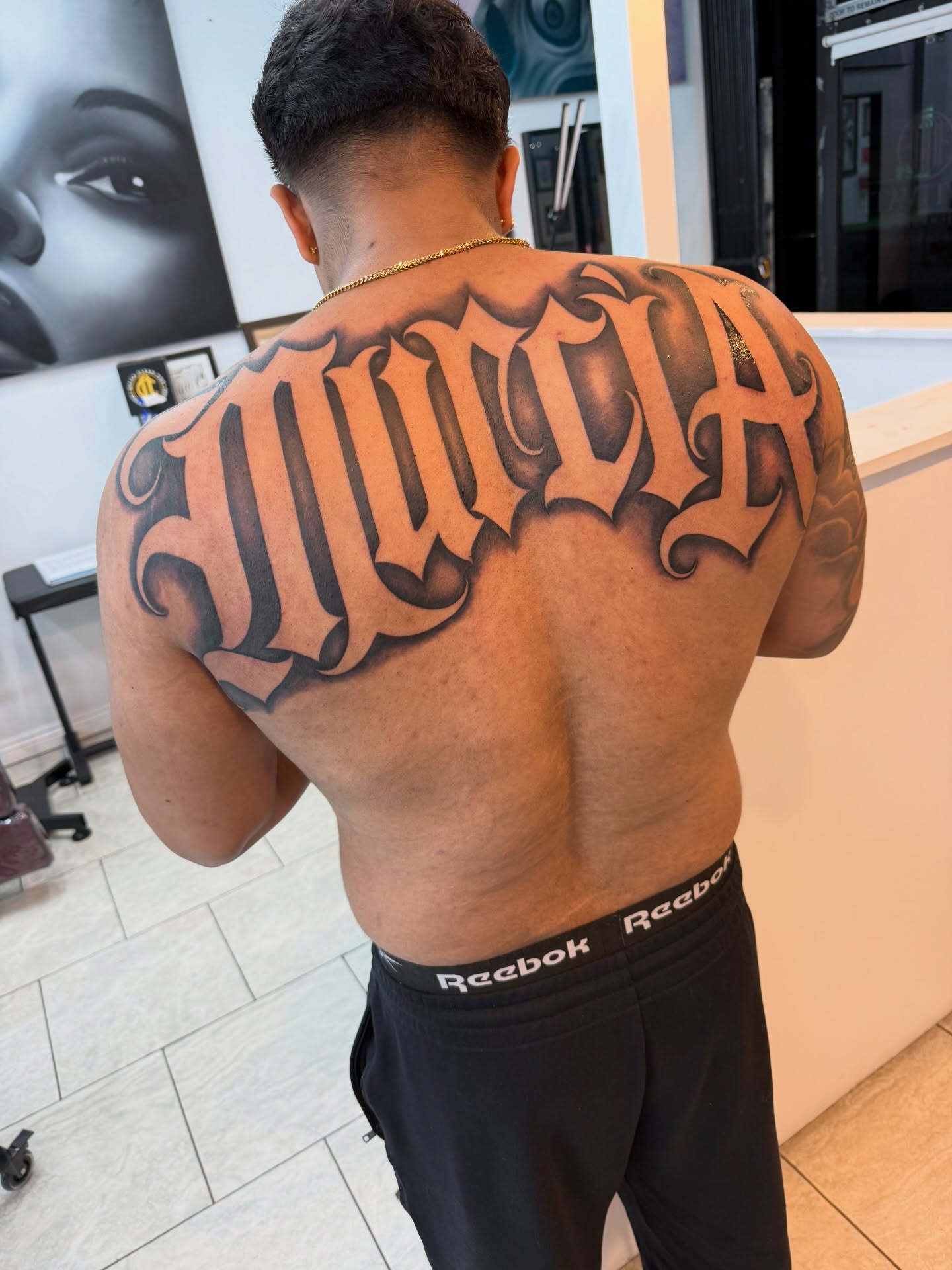 Murcia lettering script tattoo on the back by Daniel Lopez Tattoos