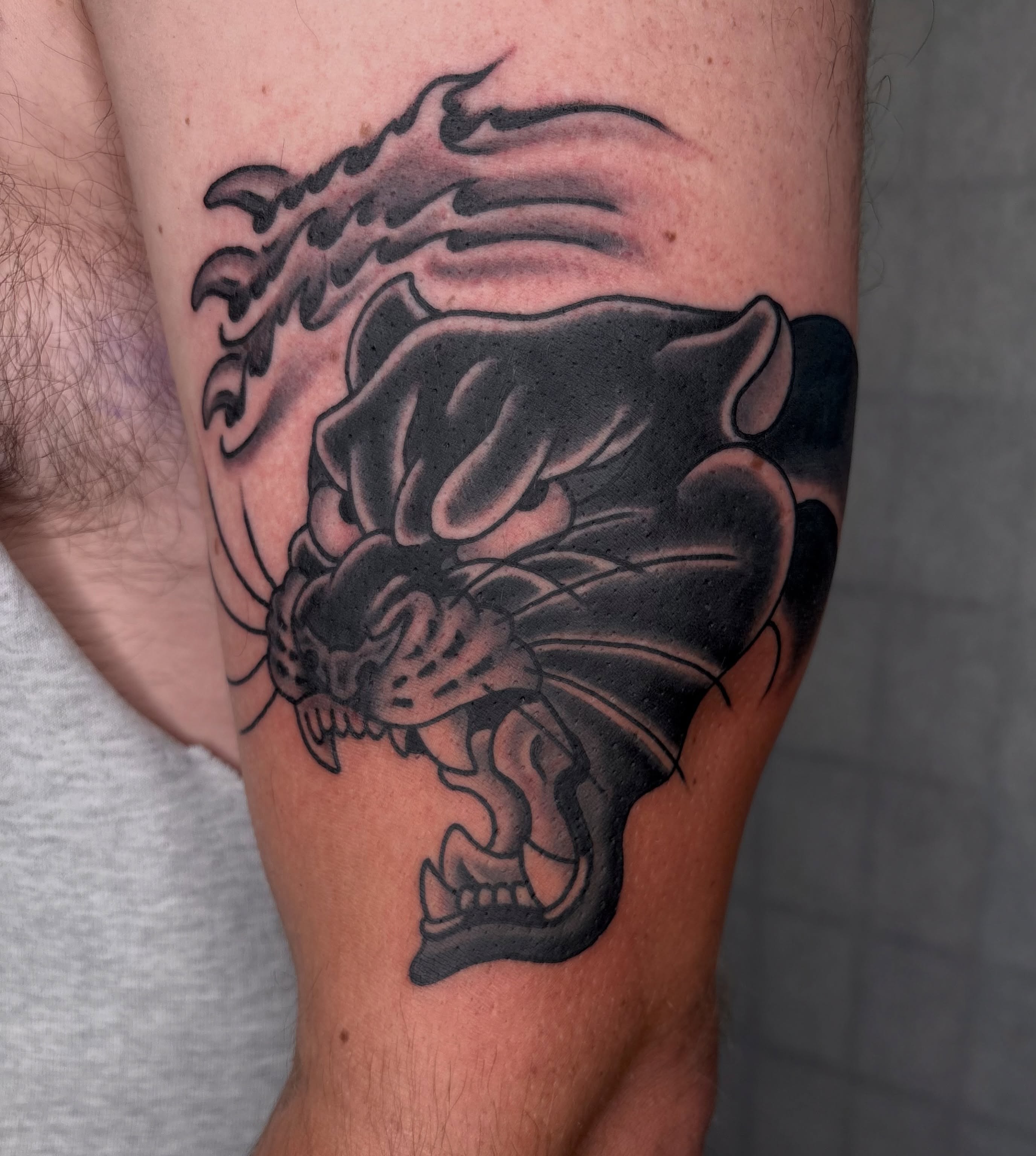 Panther black and grey tattoo on the forearm by Dallas Tattoo Artist