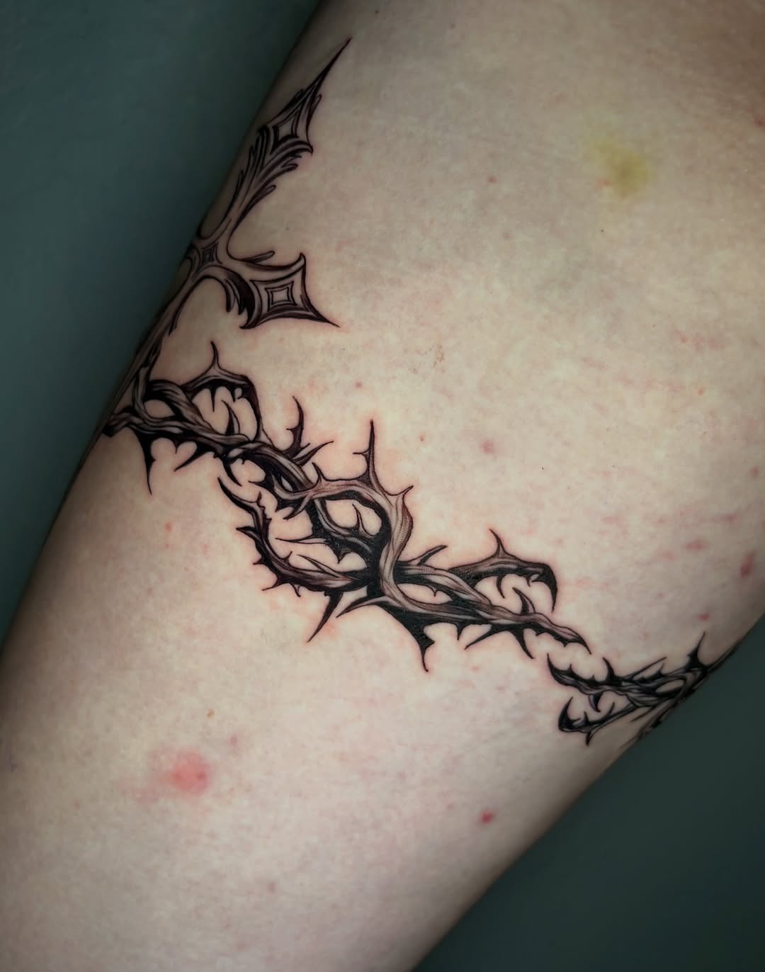 Crown of thorns and ornate cross cyber sigilism tattoo on the forearm by jayla pantig