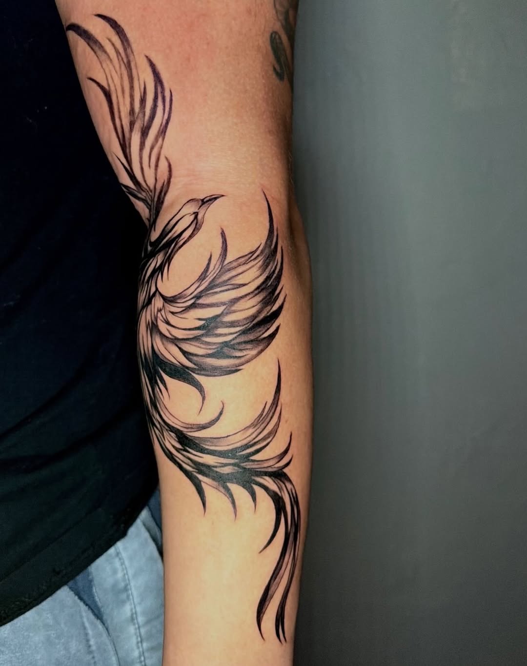 Phoenix bird watercolor tattoo on the forearm by jayla pantig