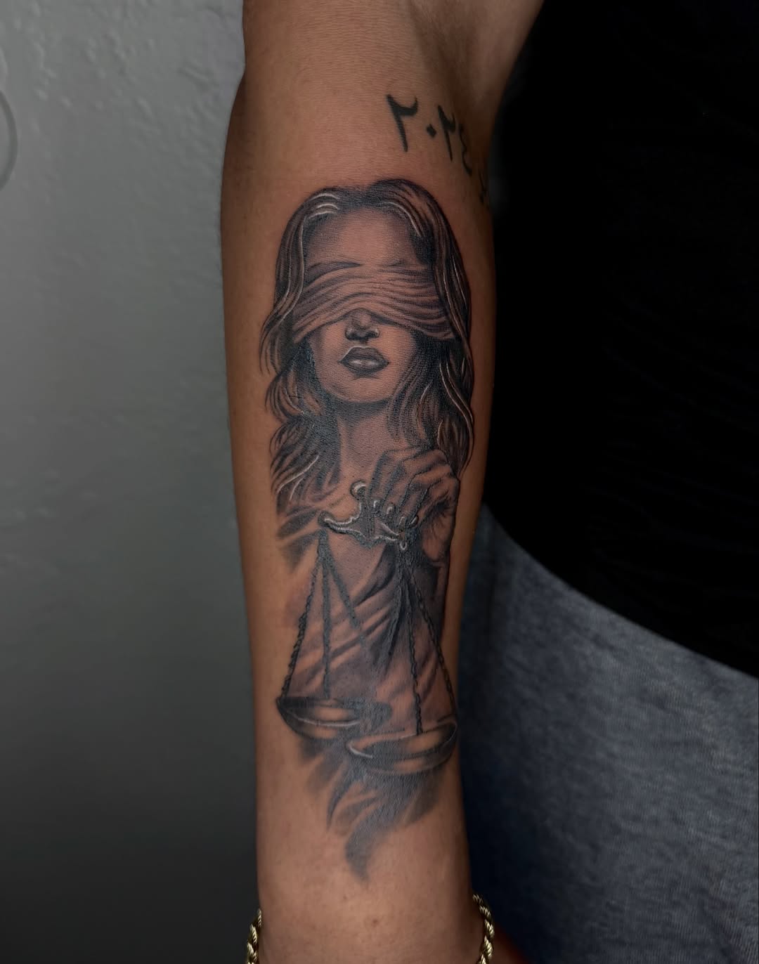 Lady Justice with blindfold and scales Chicano tattoo on the forearm by jayla pantig