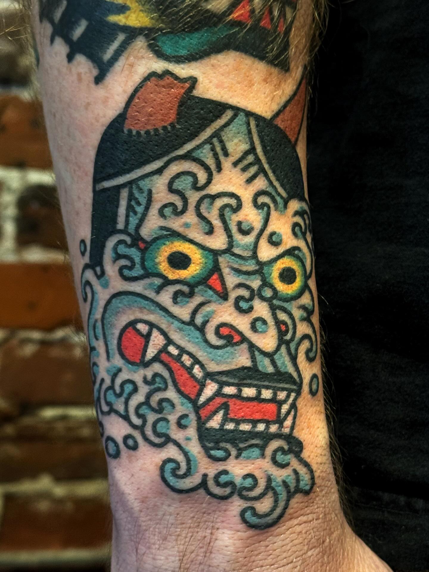 Mask American traditional tattoo on the forearm by Bryce Shearer