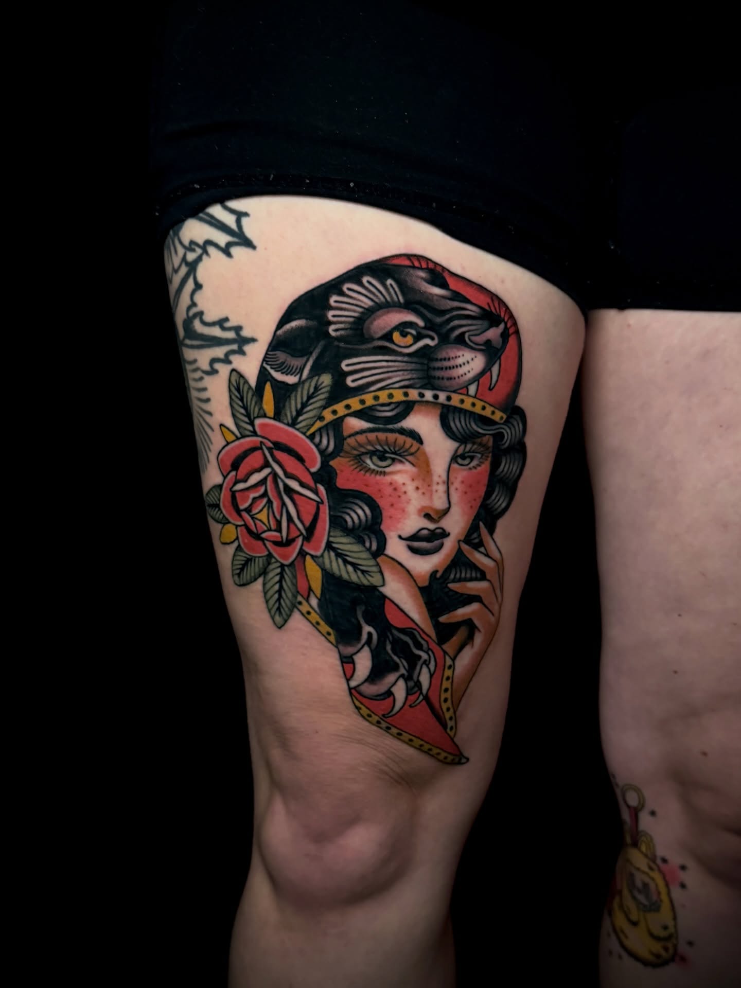 Woman with snake American traditional tattoo on the thigh by Brad Snow