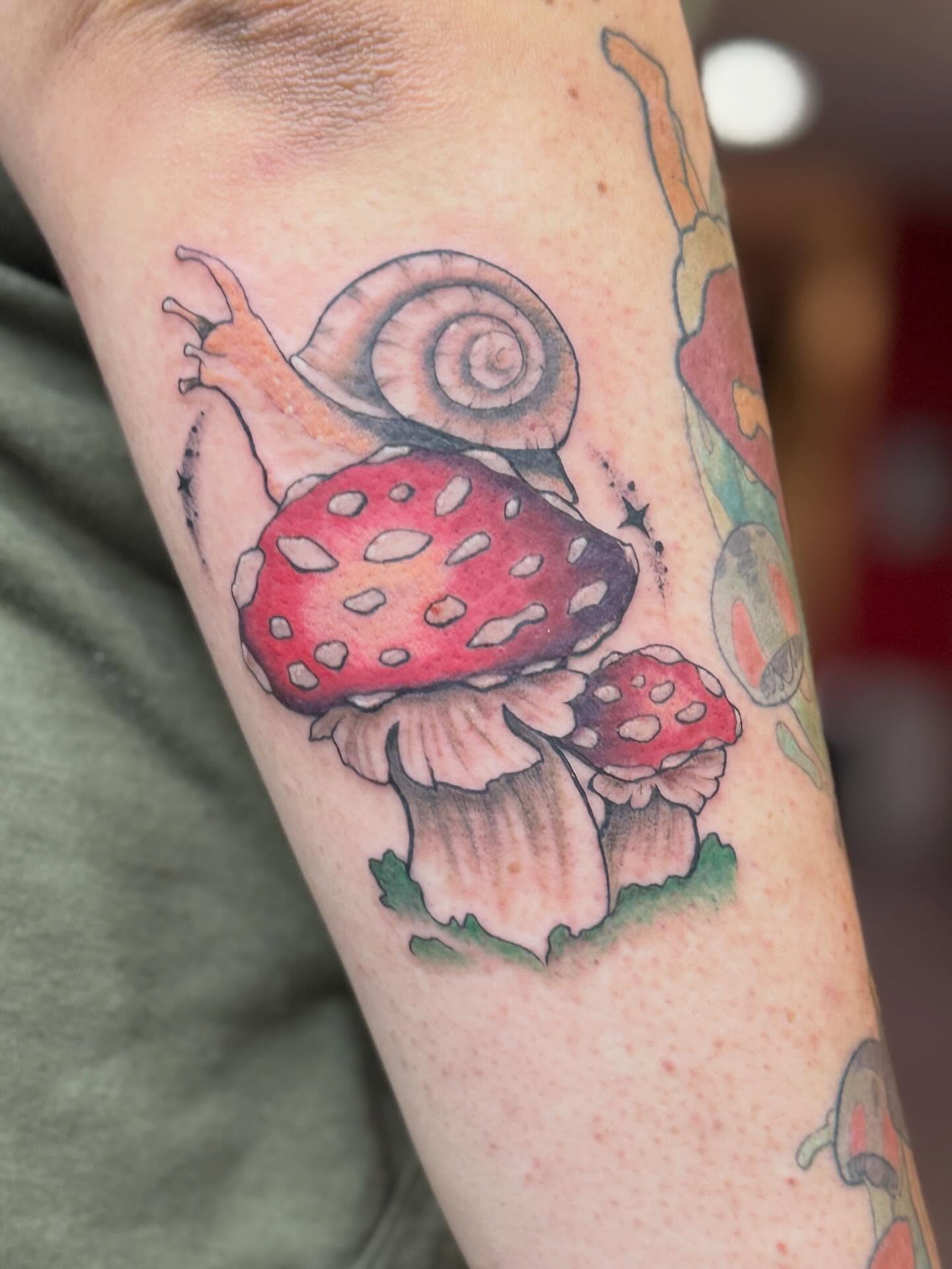 Mushroom and snail dotwork tattoo on the forearm by Rebecca Rose