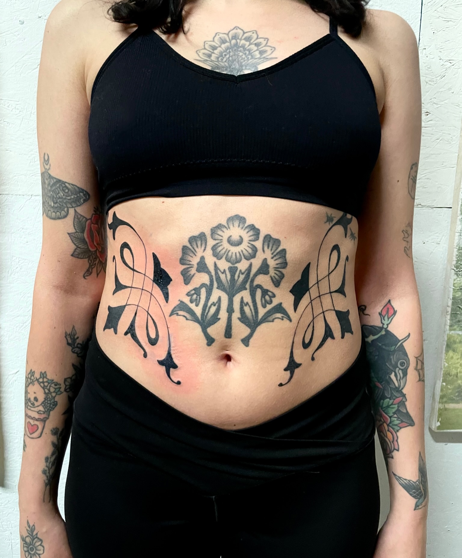 Floral arrangement black and grey tattoo on the torso by bisabuelita