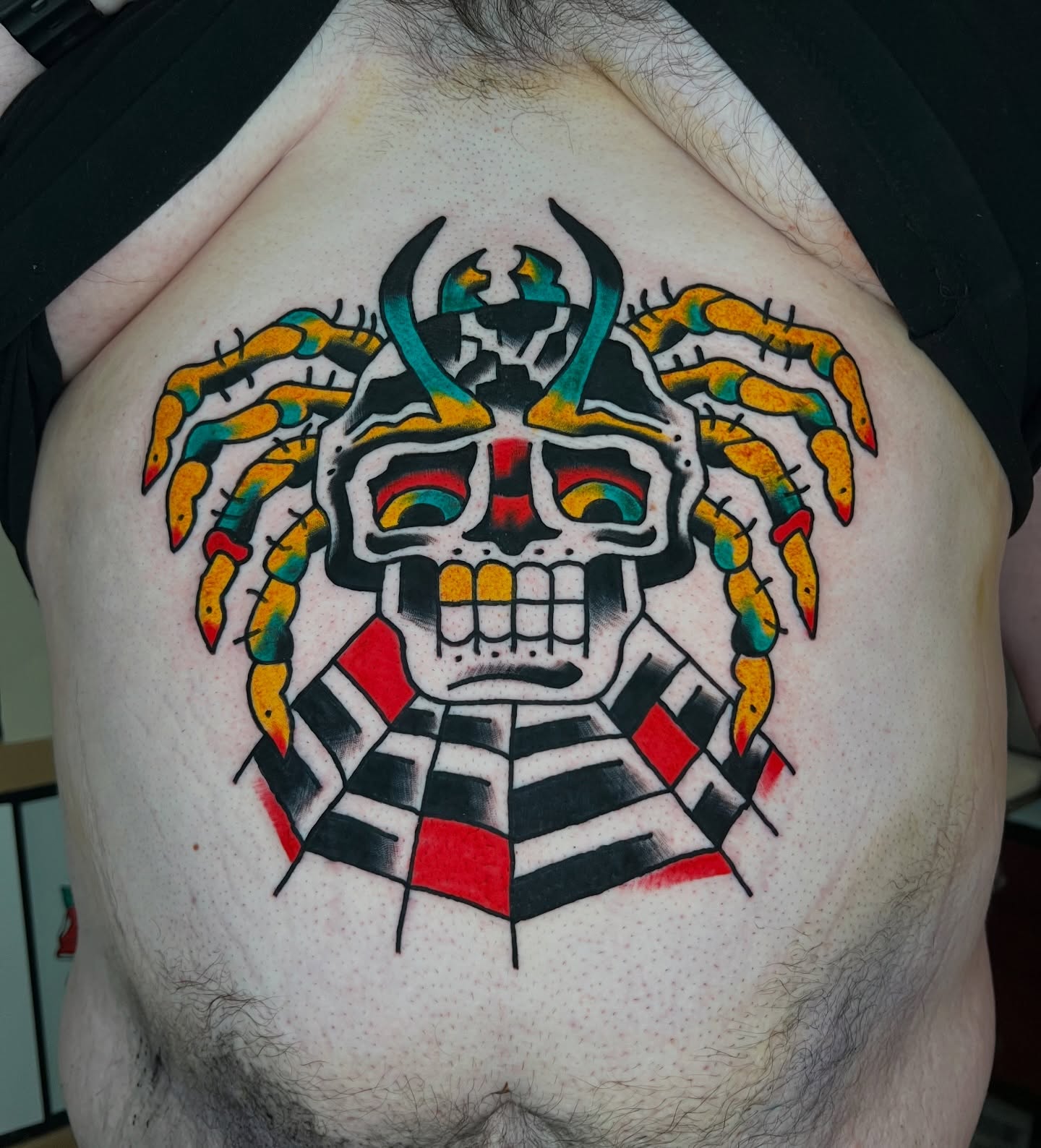 Skull with tentacles American traditional tattoo on the chest by Like A Horse Corral