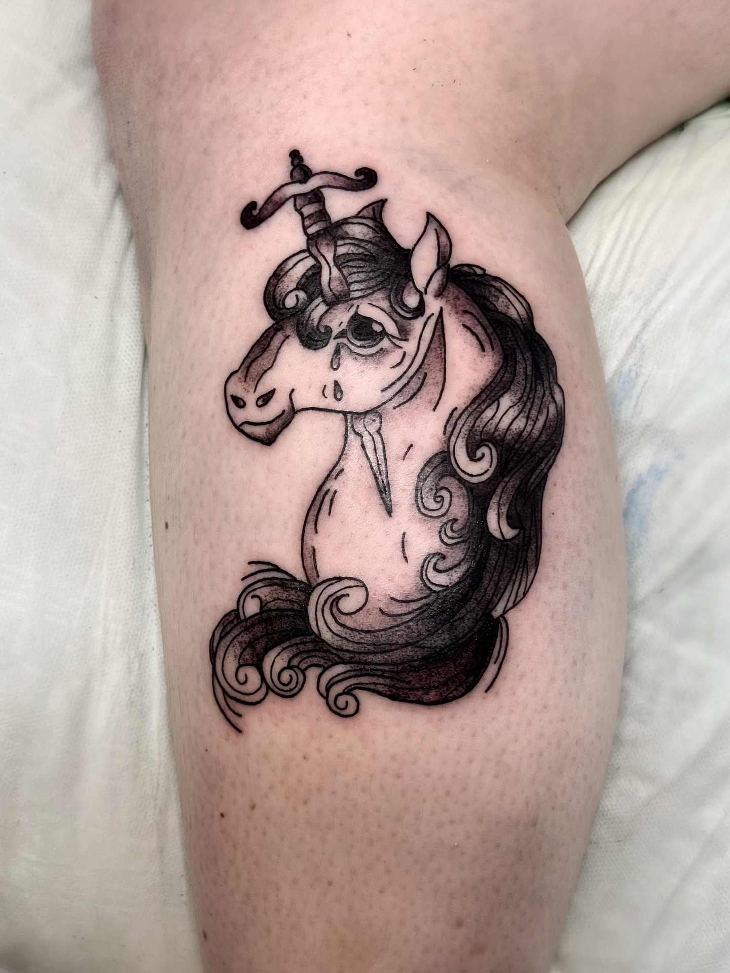 Unicorn black and grey tattoo on the thigh by Shay Cole