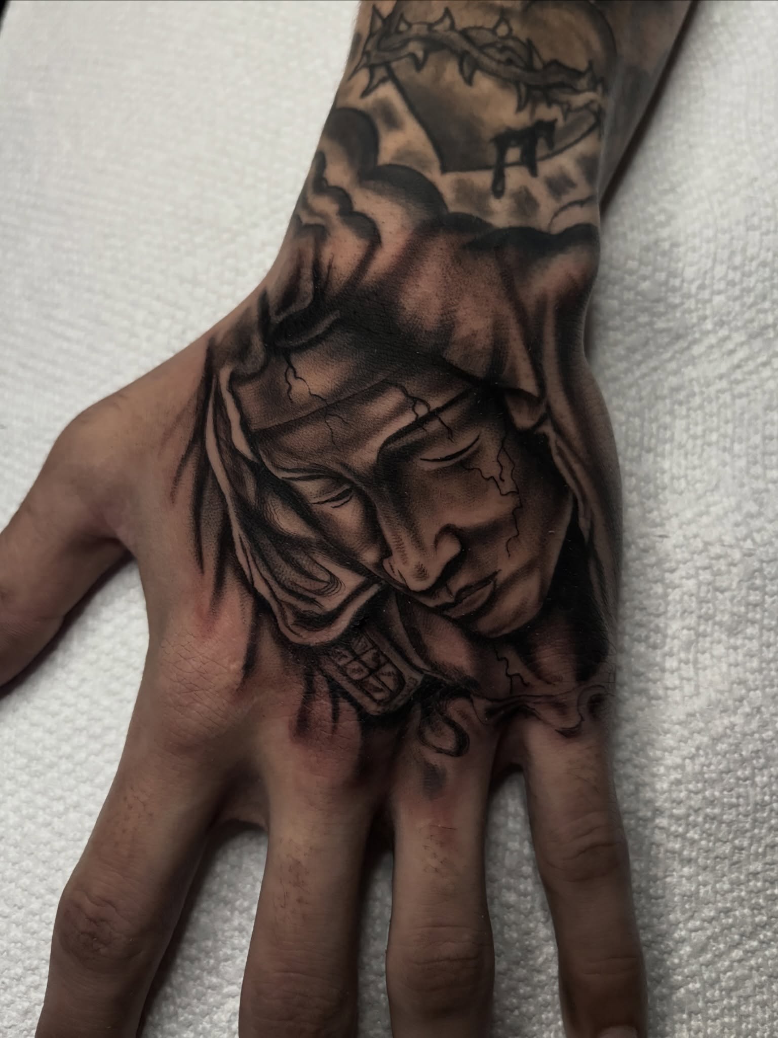 Religious figure realism tattoo on the hand by Messias Tattoo Artist