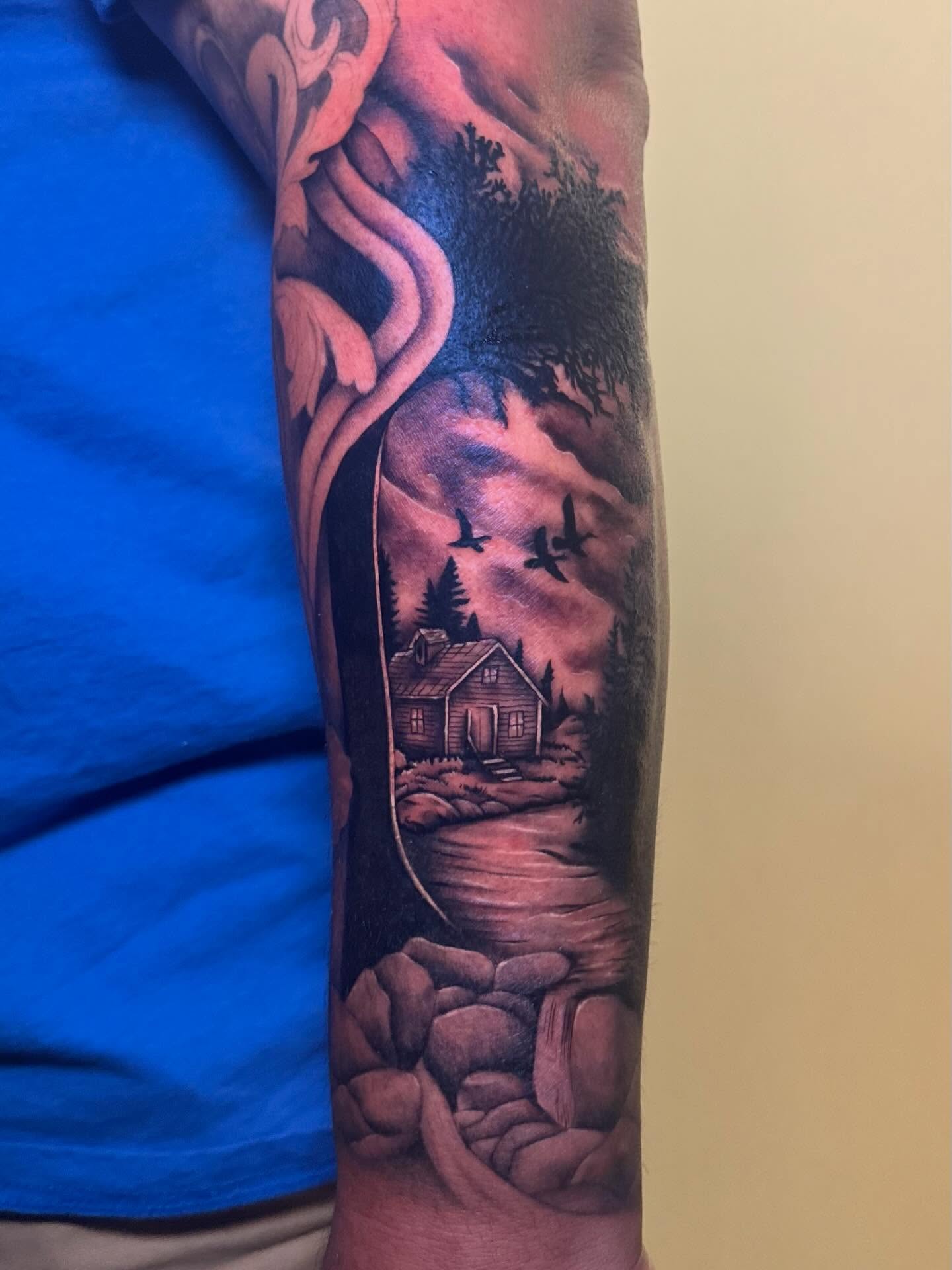 Landscape with house and birds realism tattoo on the forearm by Madison Pegram