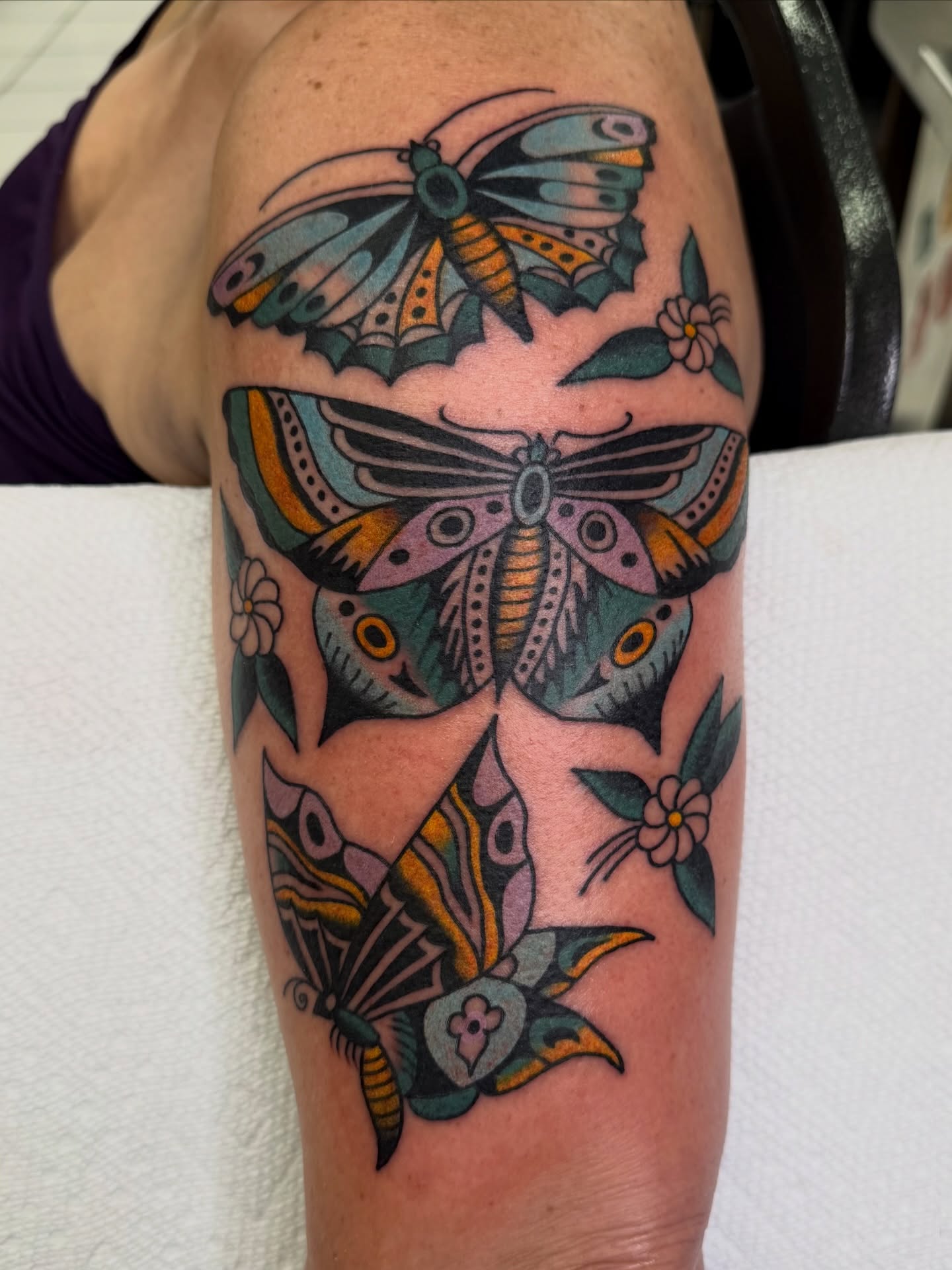 Moths and flowers American traditional tattoo on the forearm by morganhabe