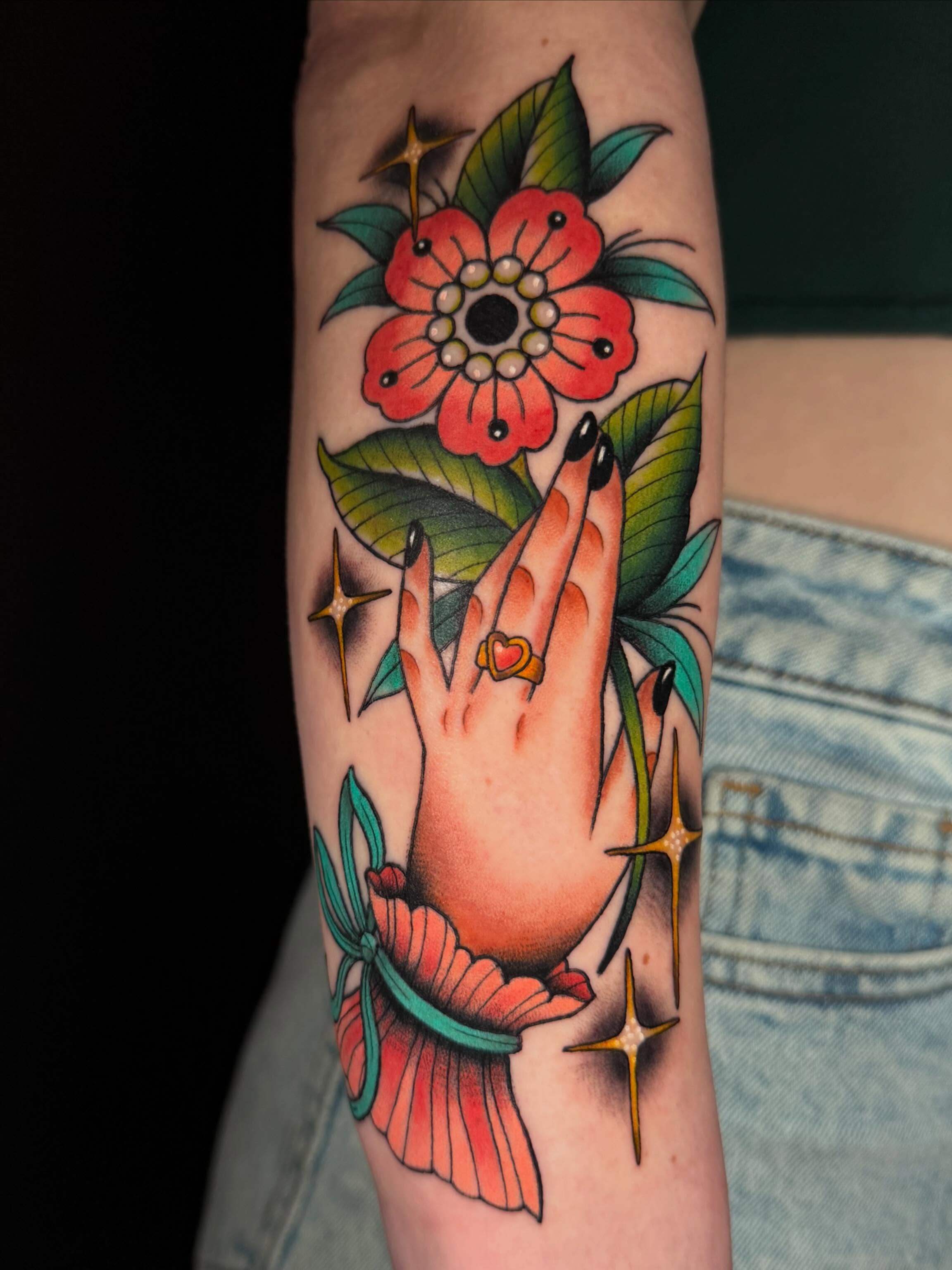 Praying hands with flower American traditional tattoo on the forearm by ♥︎ ᴅᴇᴠ ʀᴇɴᴇᴇ ♥︎