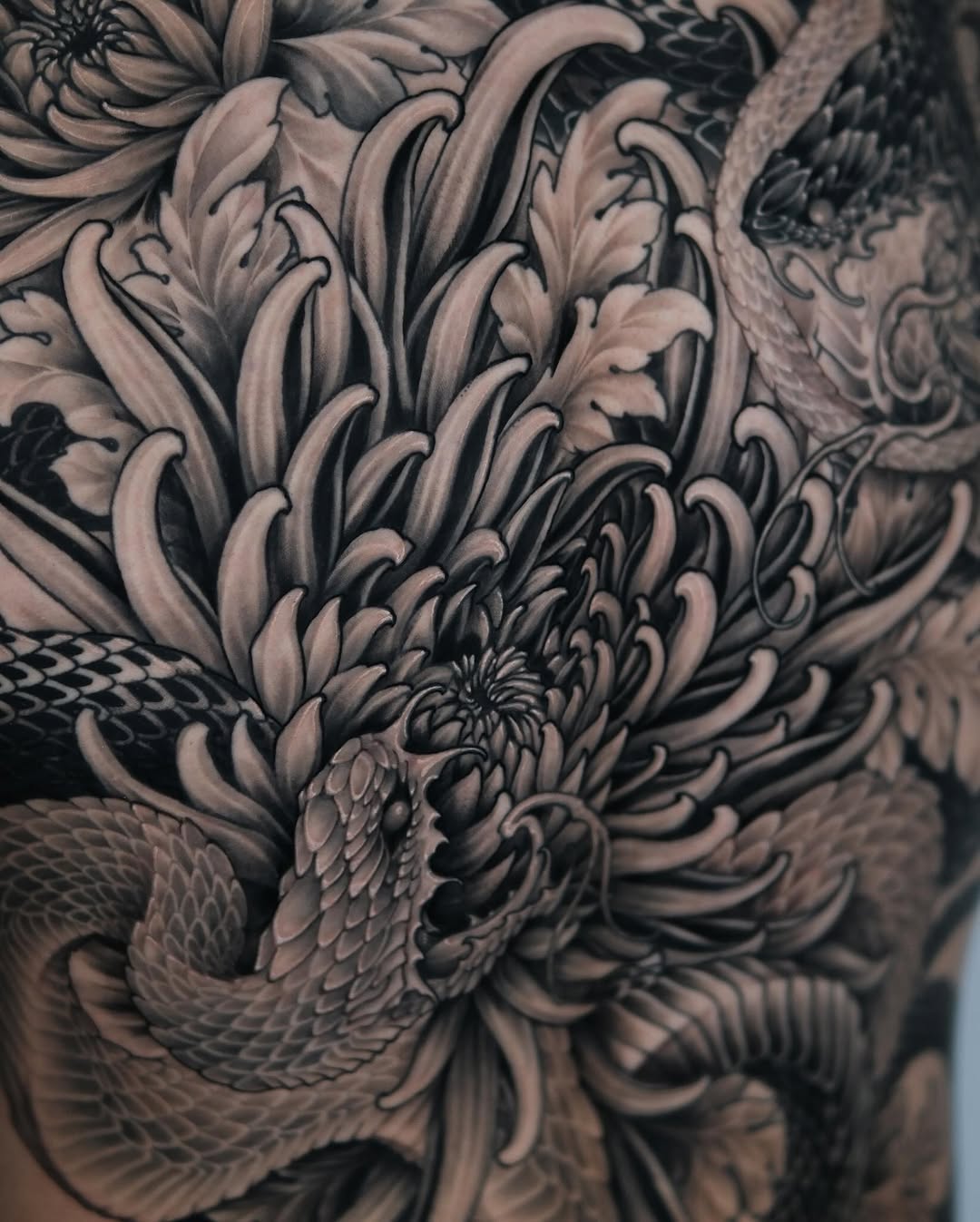 Snake and chrysanthemum Japanese tattoo by Yujin Ju