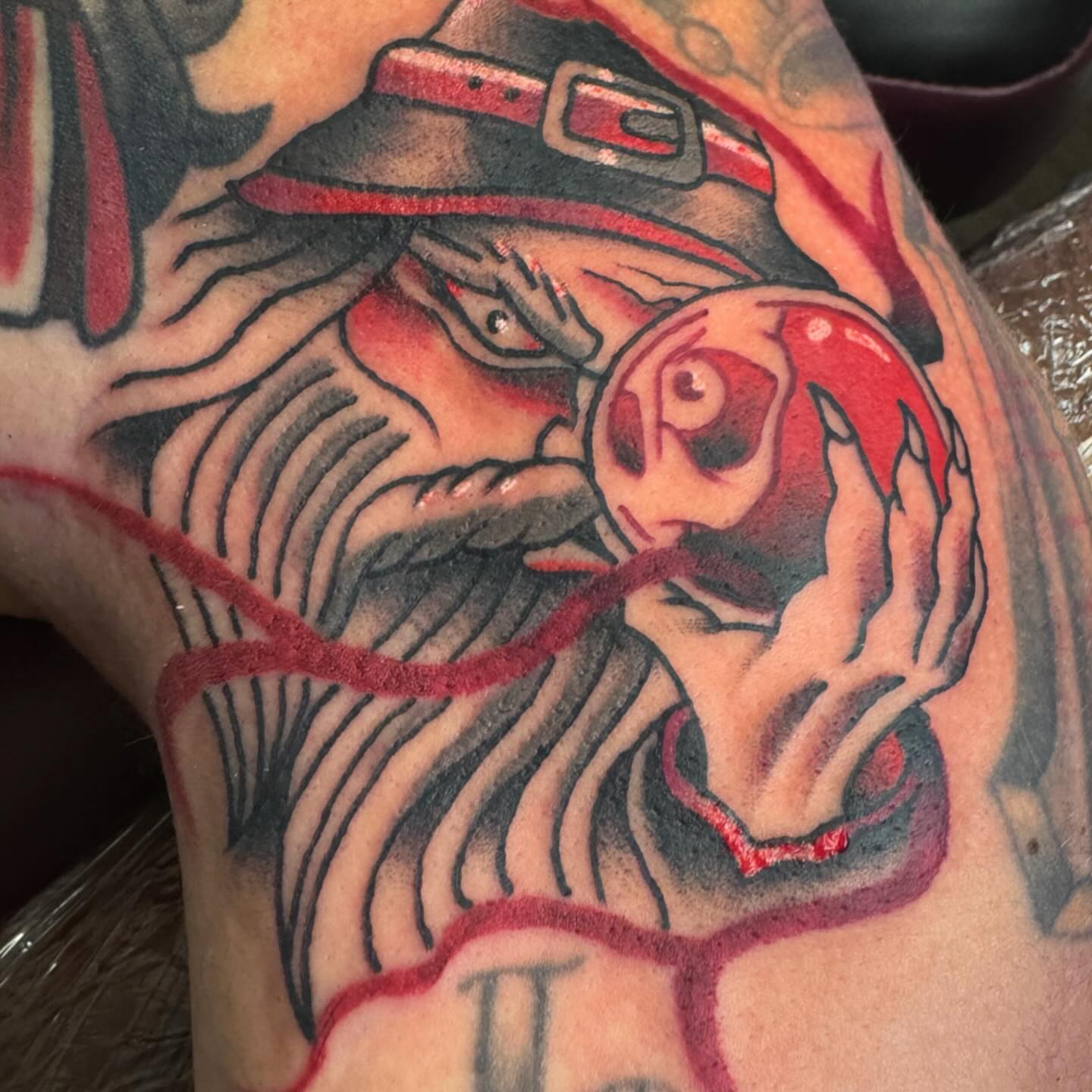 Witch with apple American traditional tattoo on the shoulder by Dylan Walker