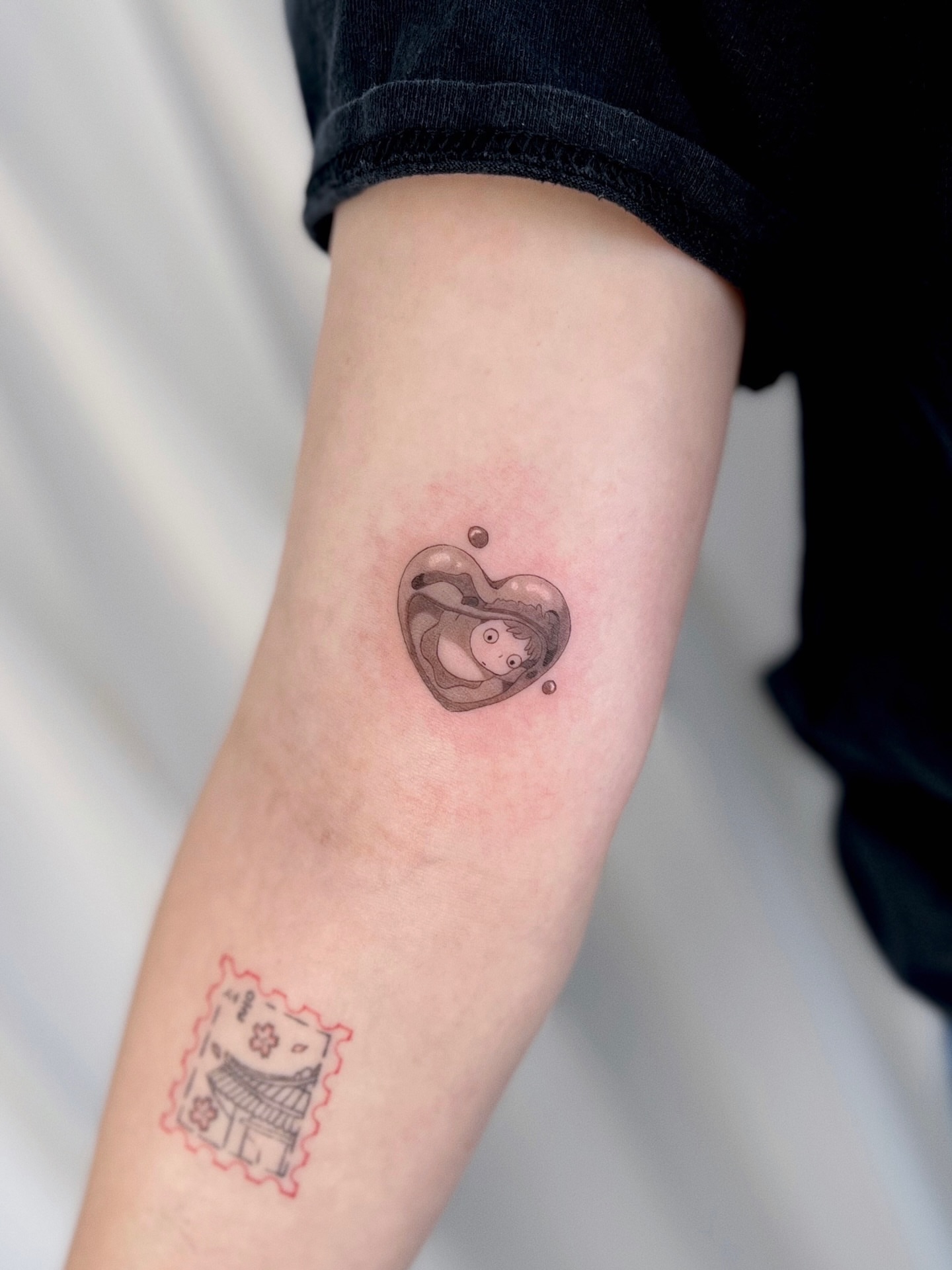 Heart with figure dotwork tattoo on the forearm by Soy 🫛