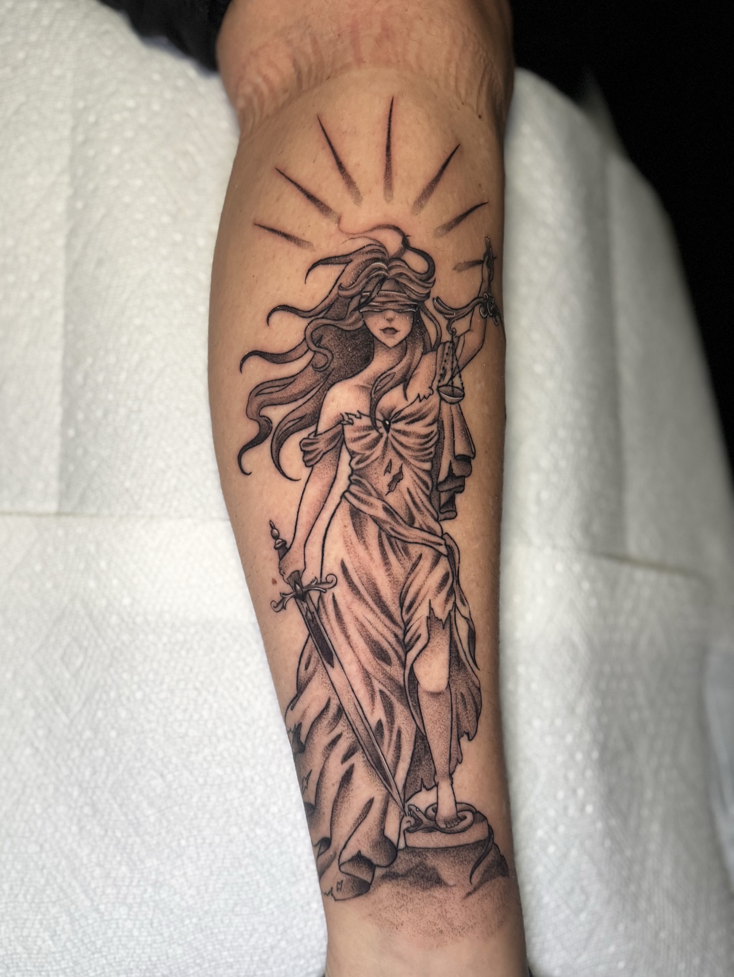Statue of justice black and grey tattoo on the forearm by 𝕹𝖆𝖙