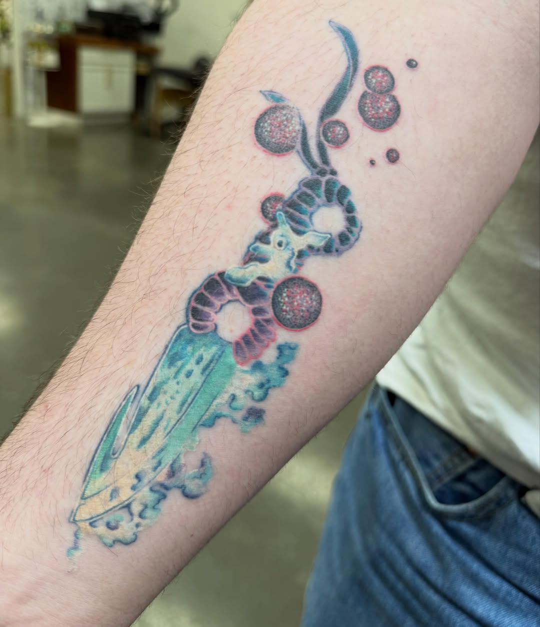 Astronaut with cosmic elements new school tattoo on the forearm by LiteBriteTattoo, Salt Lake City, Utah