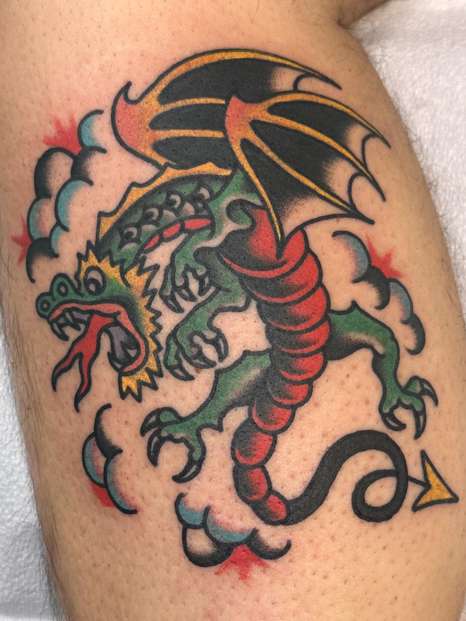 Dragon American traditional tattoo on the upper arm by Cody Woolard, Seymour, Tennessee